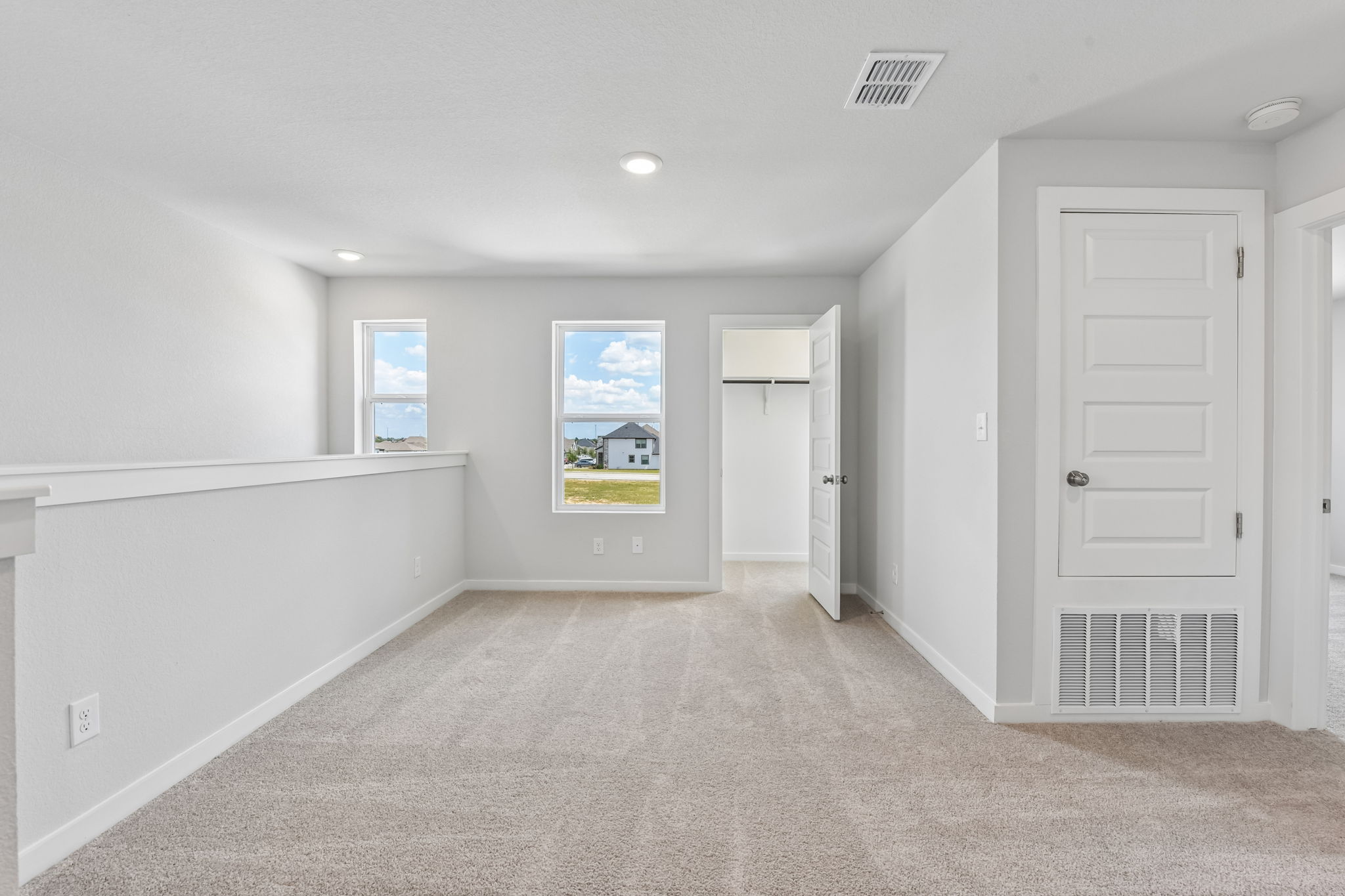 A room with white walls and a window.