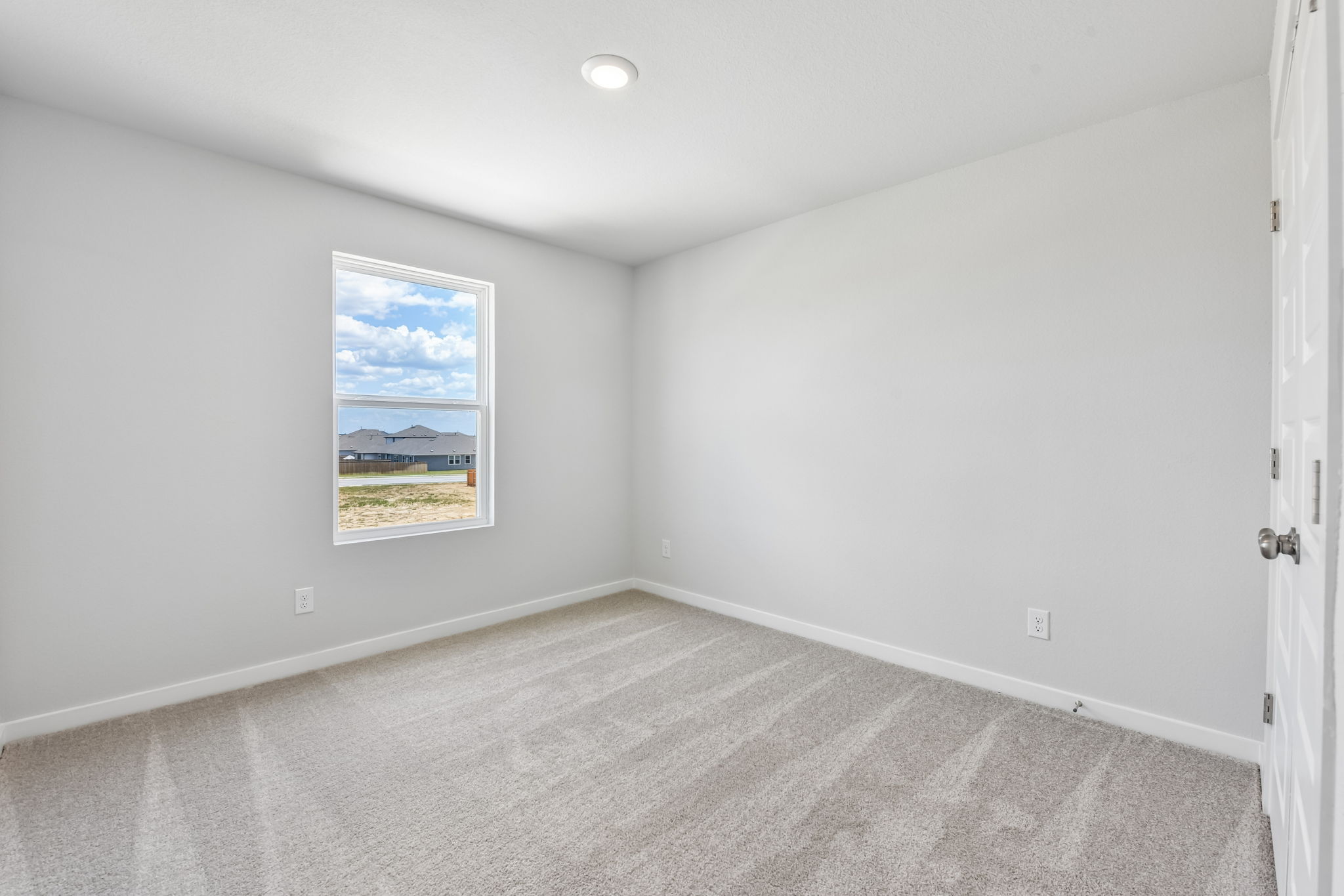 A room with a painting on the wall.