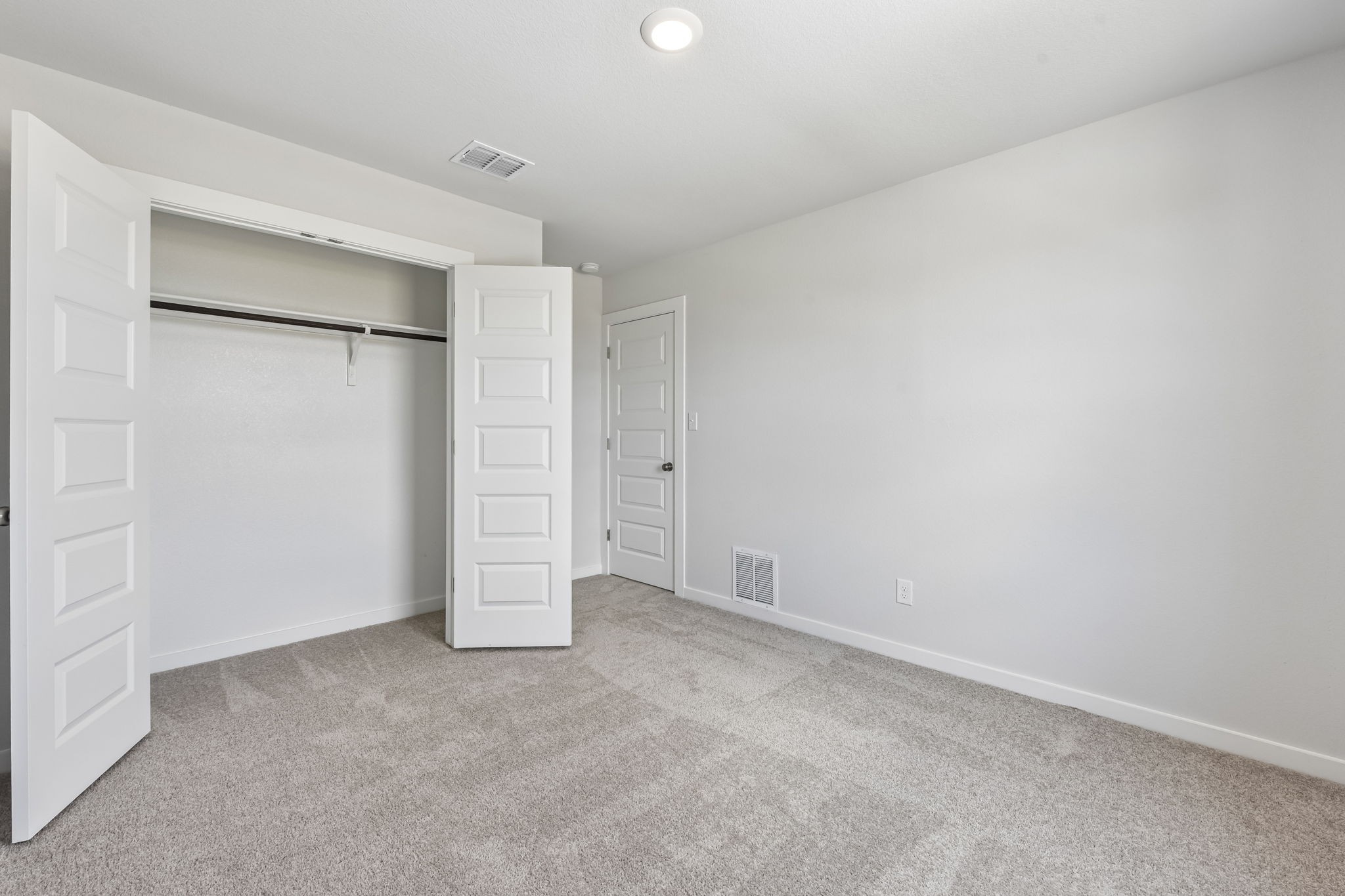 A room with white cabinets.