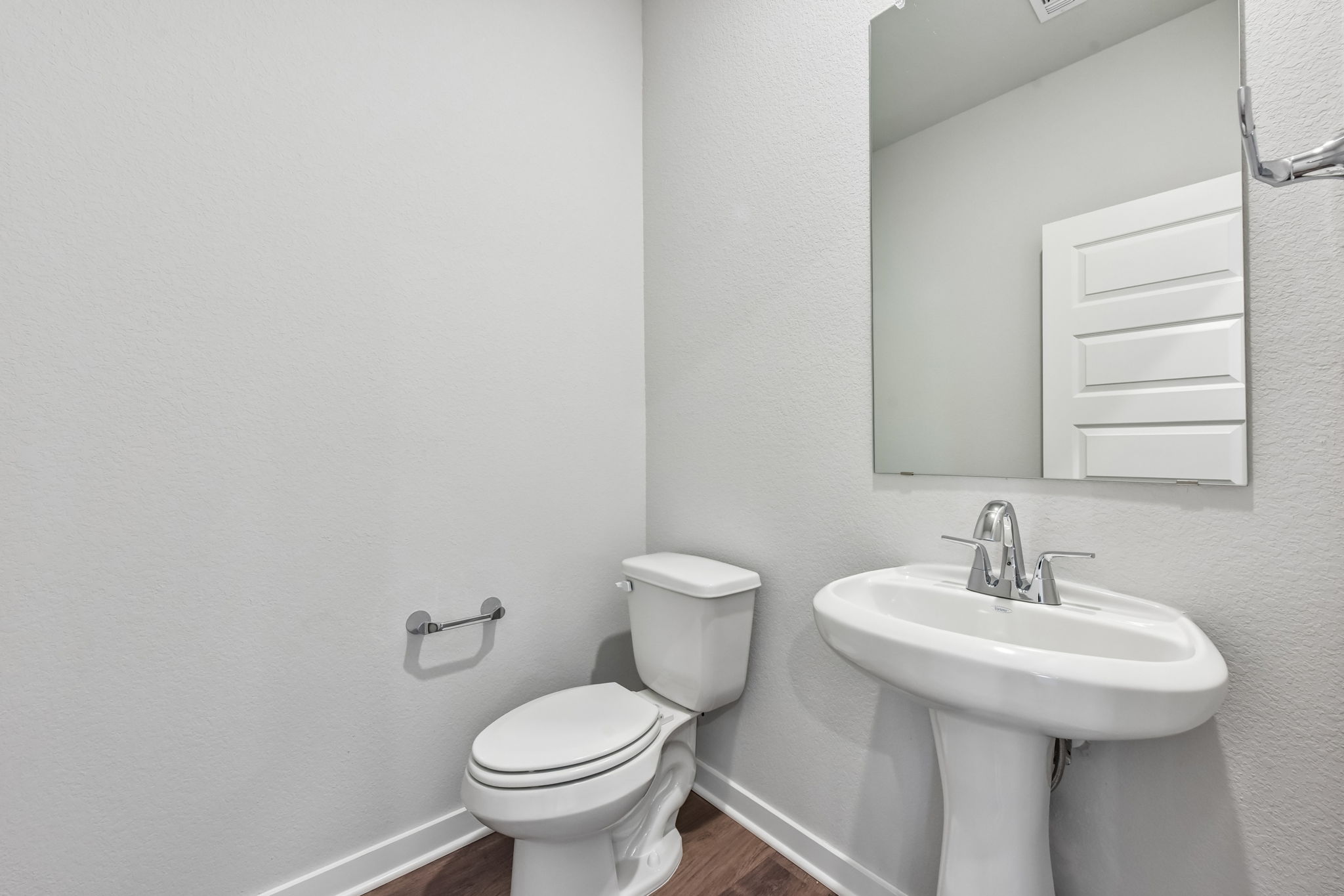 A bathroom with a toilet and sink.