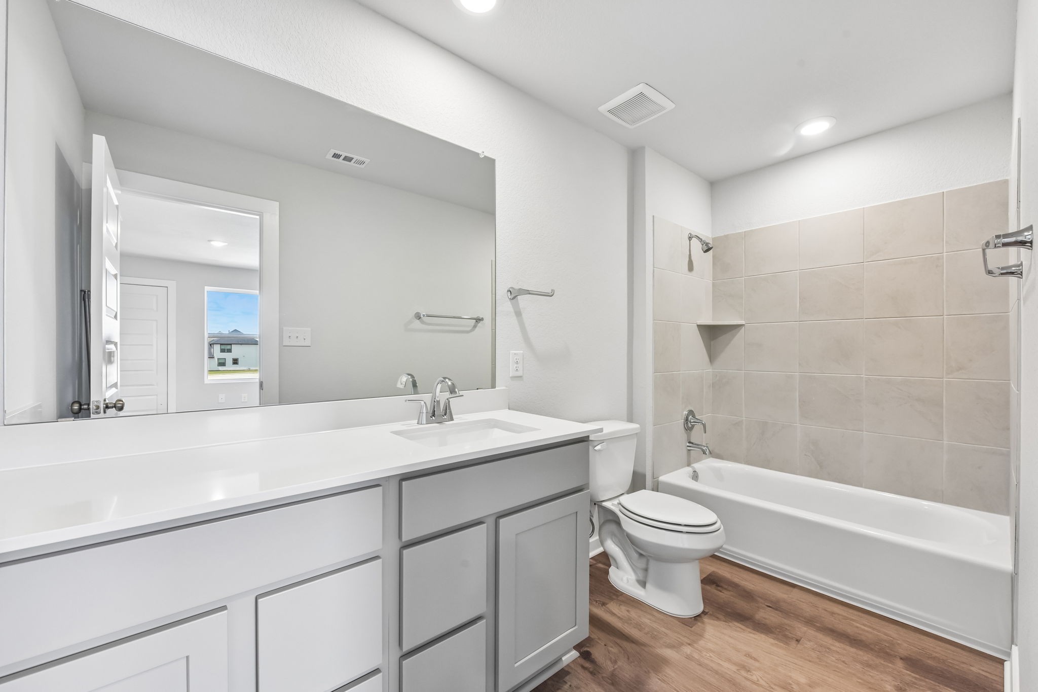 A bathroom with a tub toilet and sink.