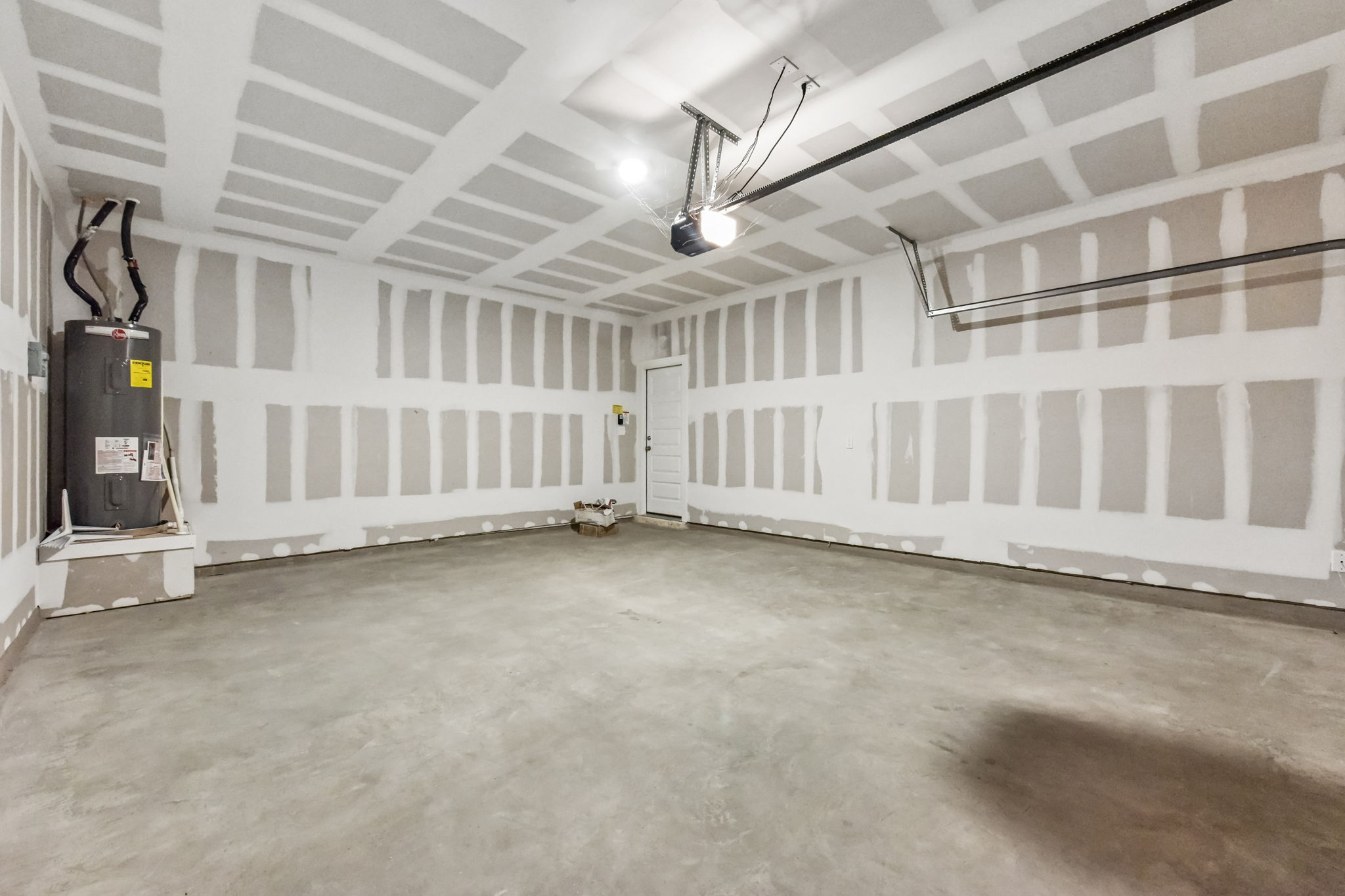 A room with a white wall and a black box.