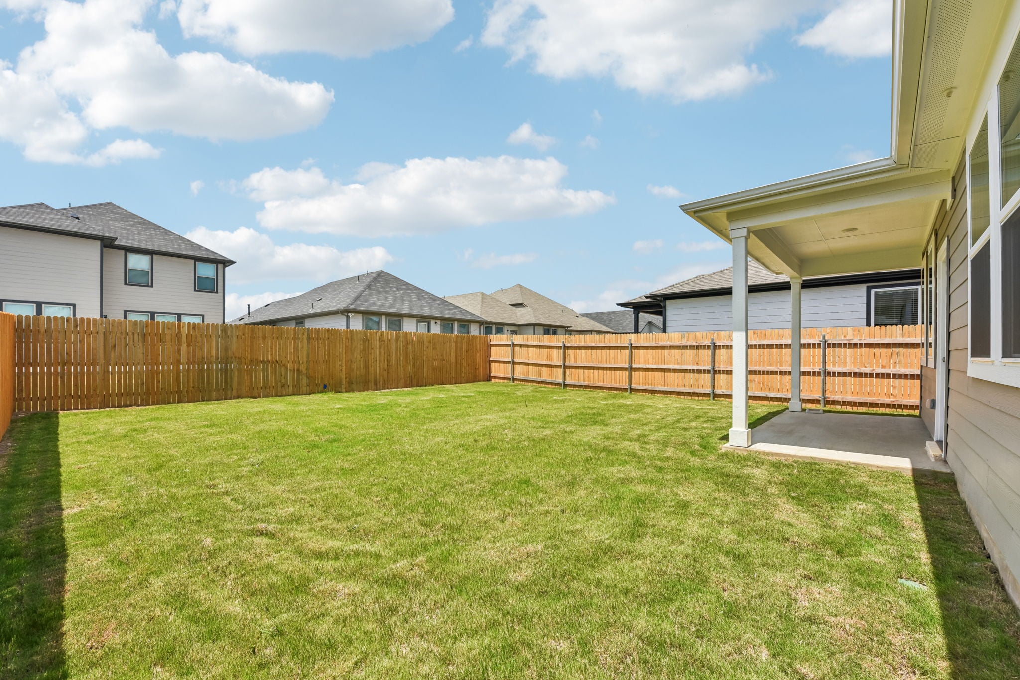 A fenced yard with a house and a fence.