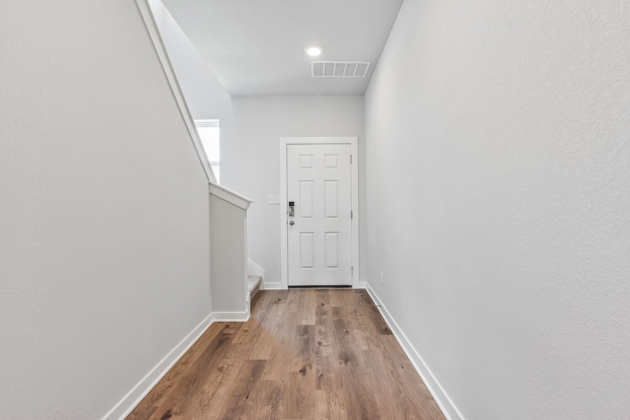A hallway with white walls.