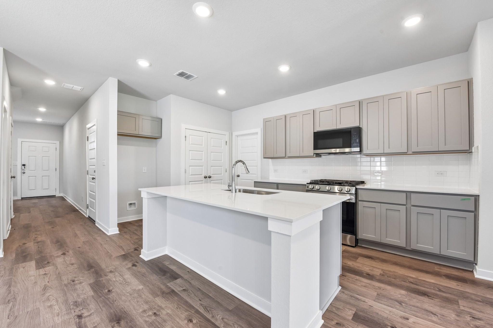 A kitchen with white cabinets.