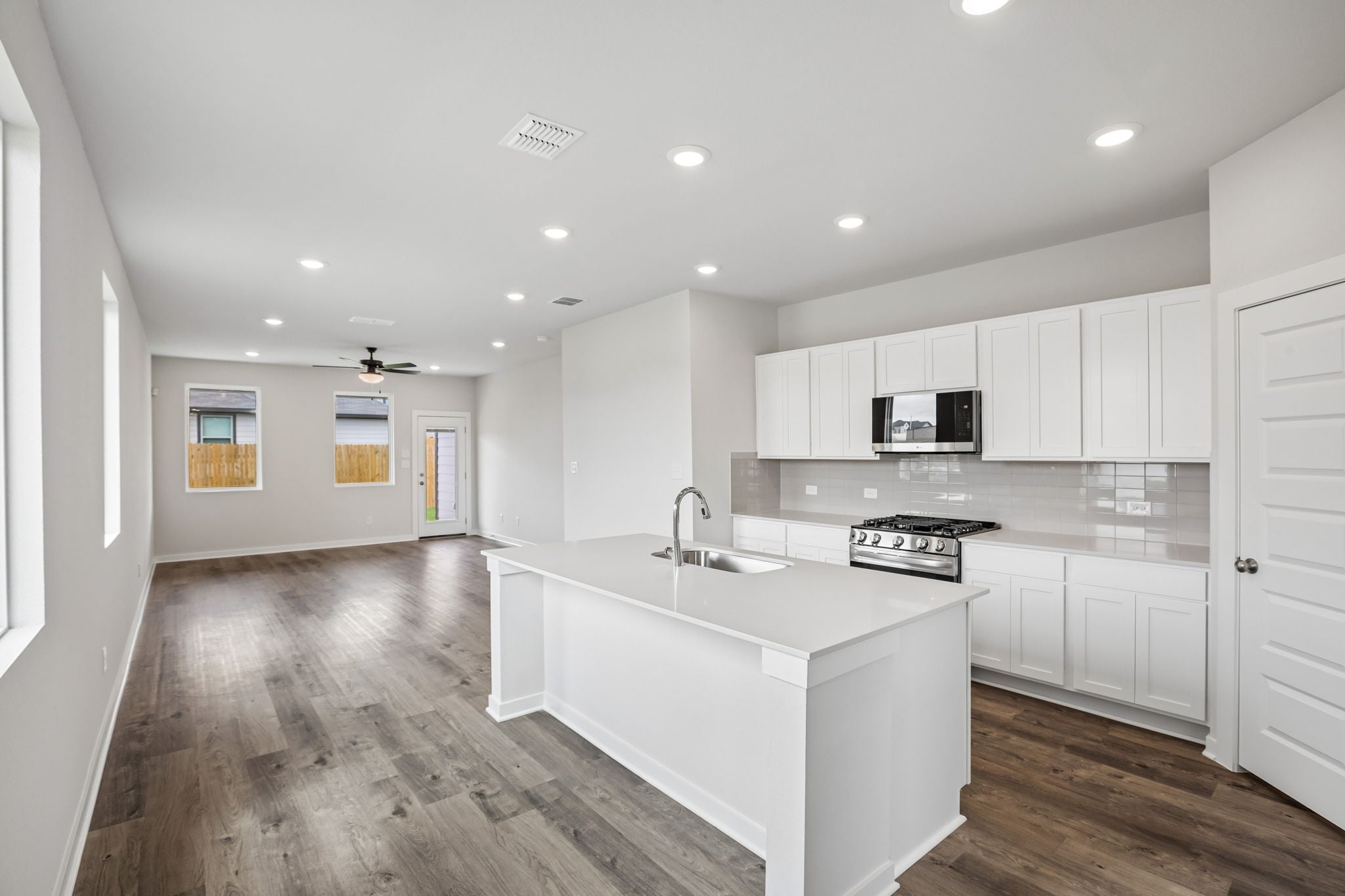 A kitchen with white cabinets.