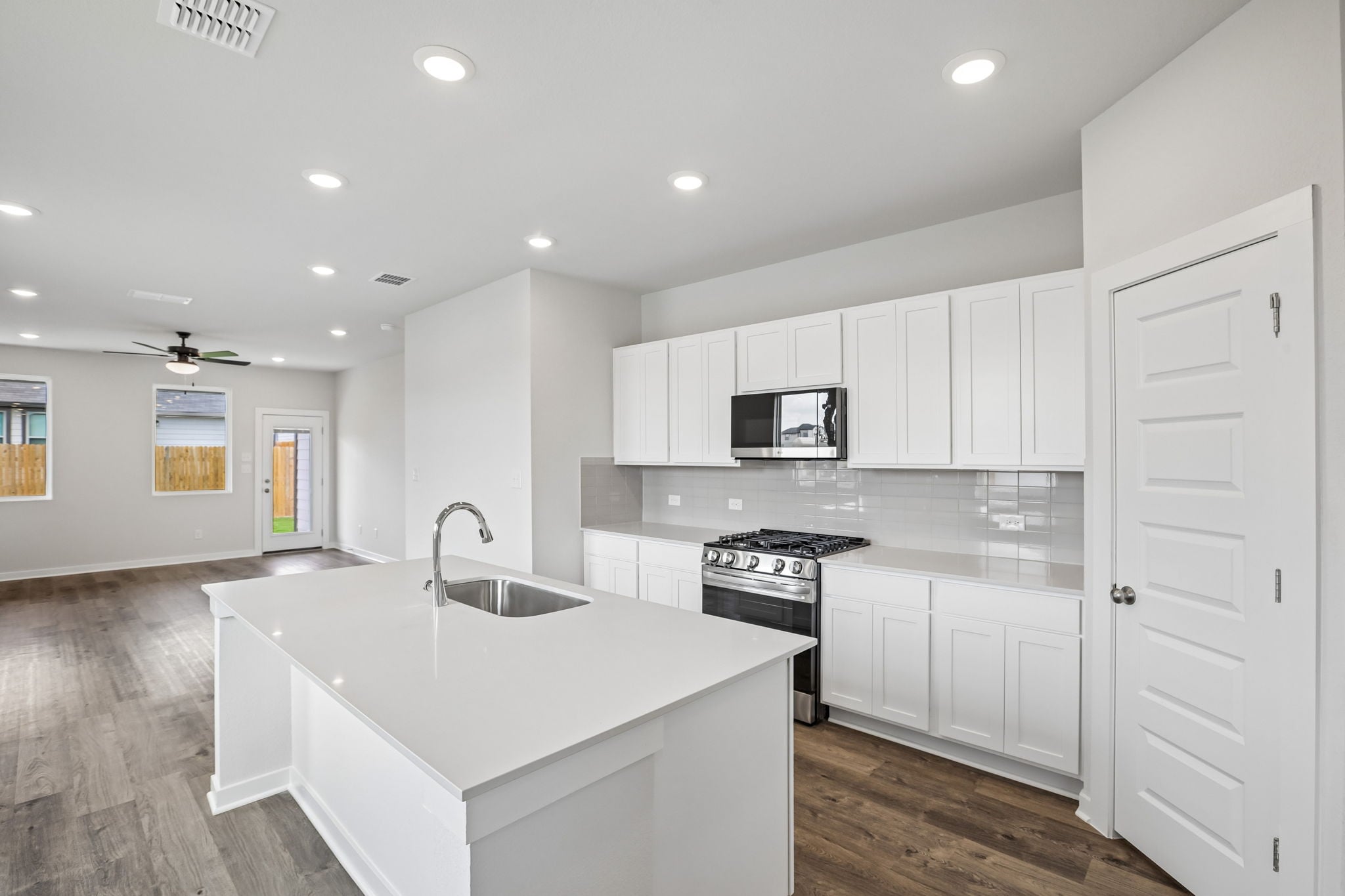 A kitchen with white cabinets.