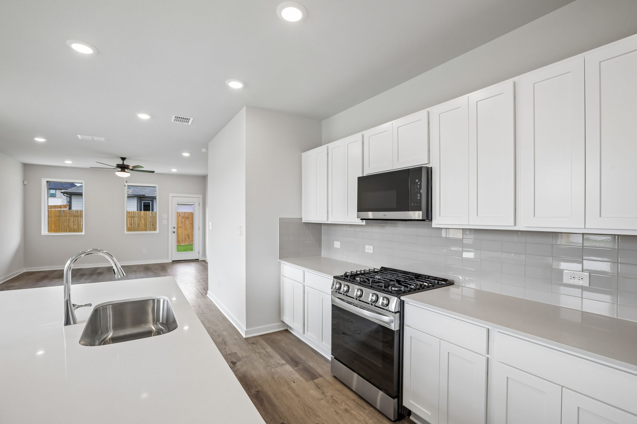 A kitchen with white cabinets.
