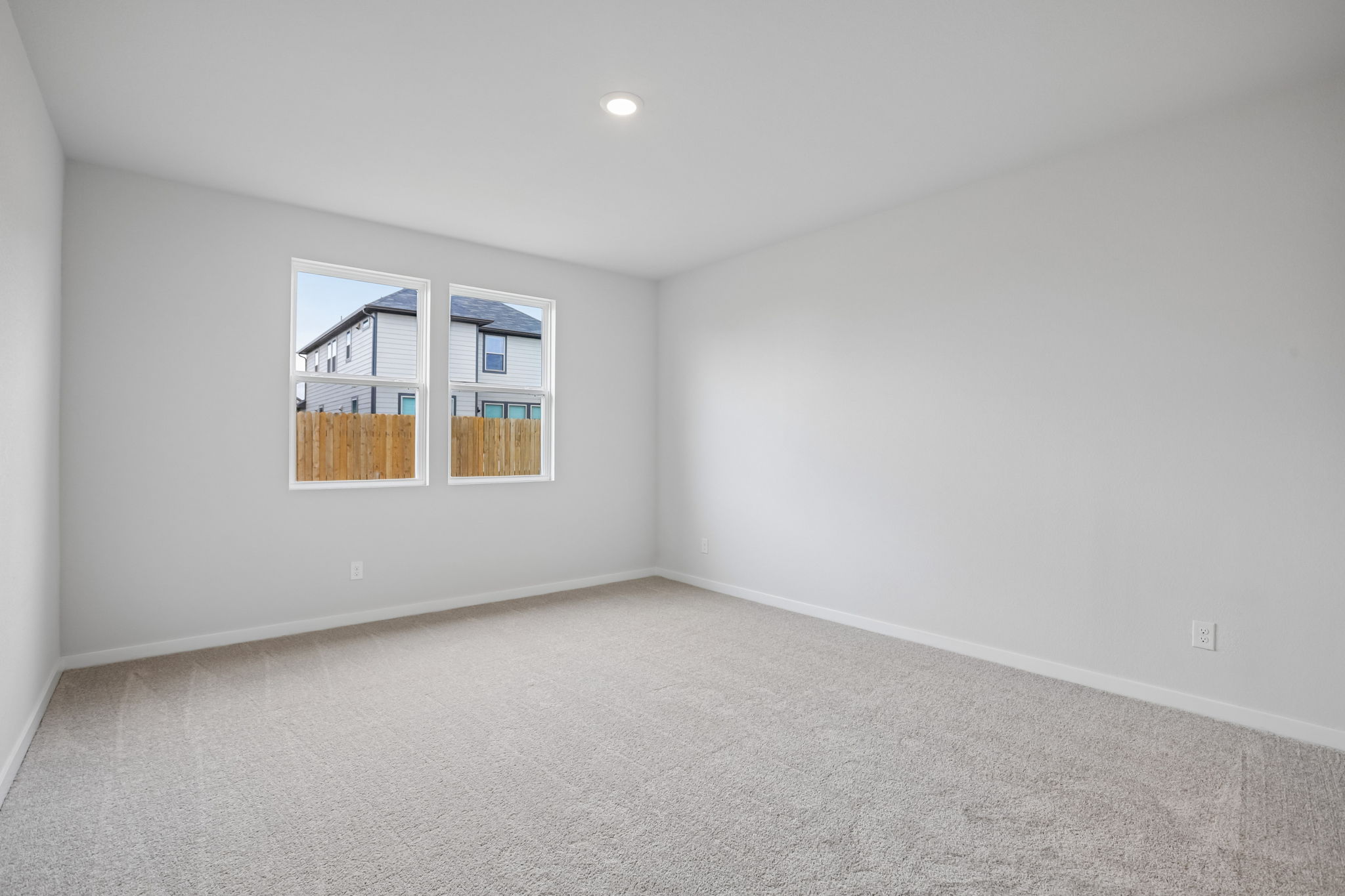 A room with a window and a carpet.
