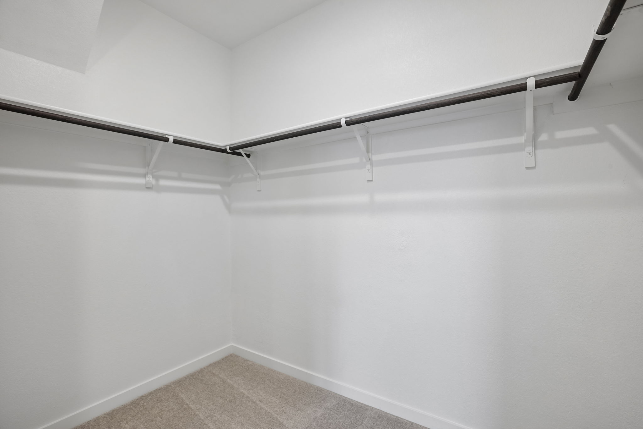 A white wall with a metal railing.