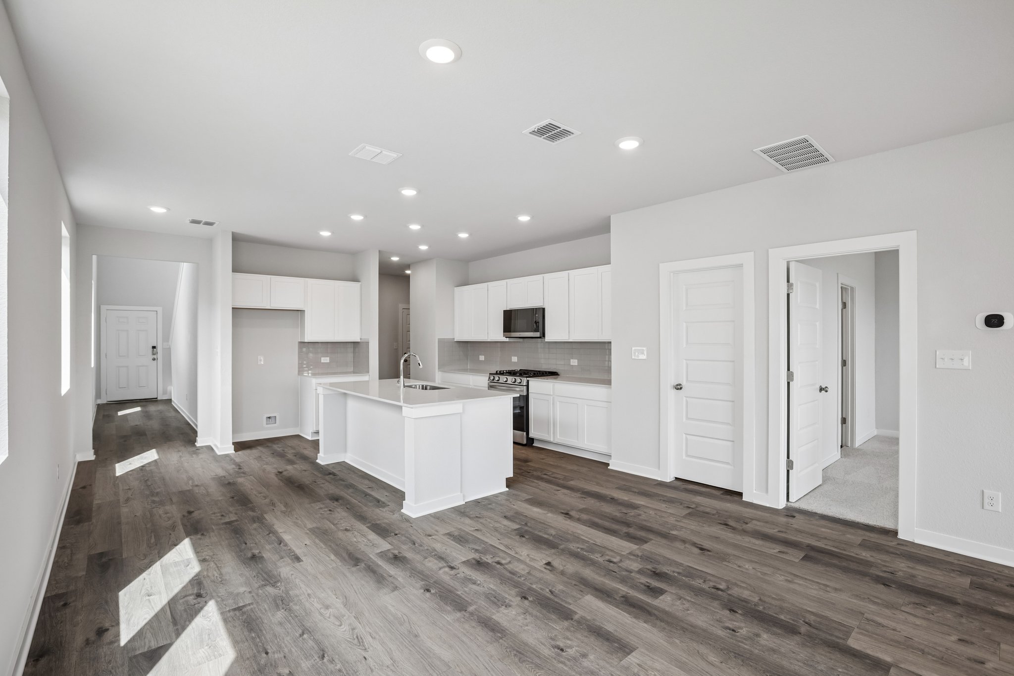 A large kitchen with white cabinets.