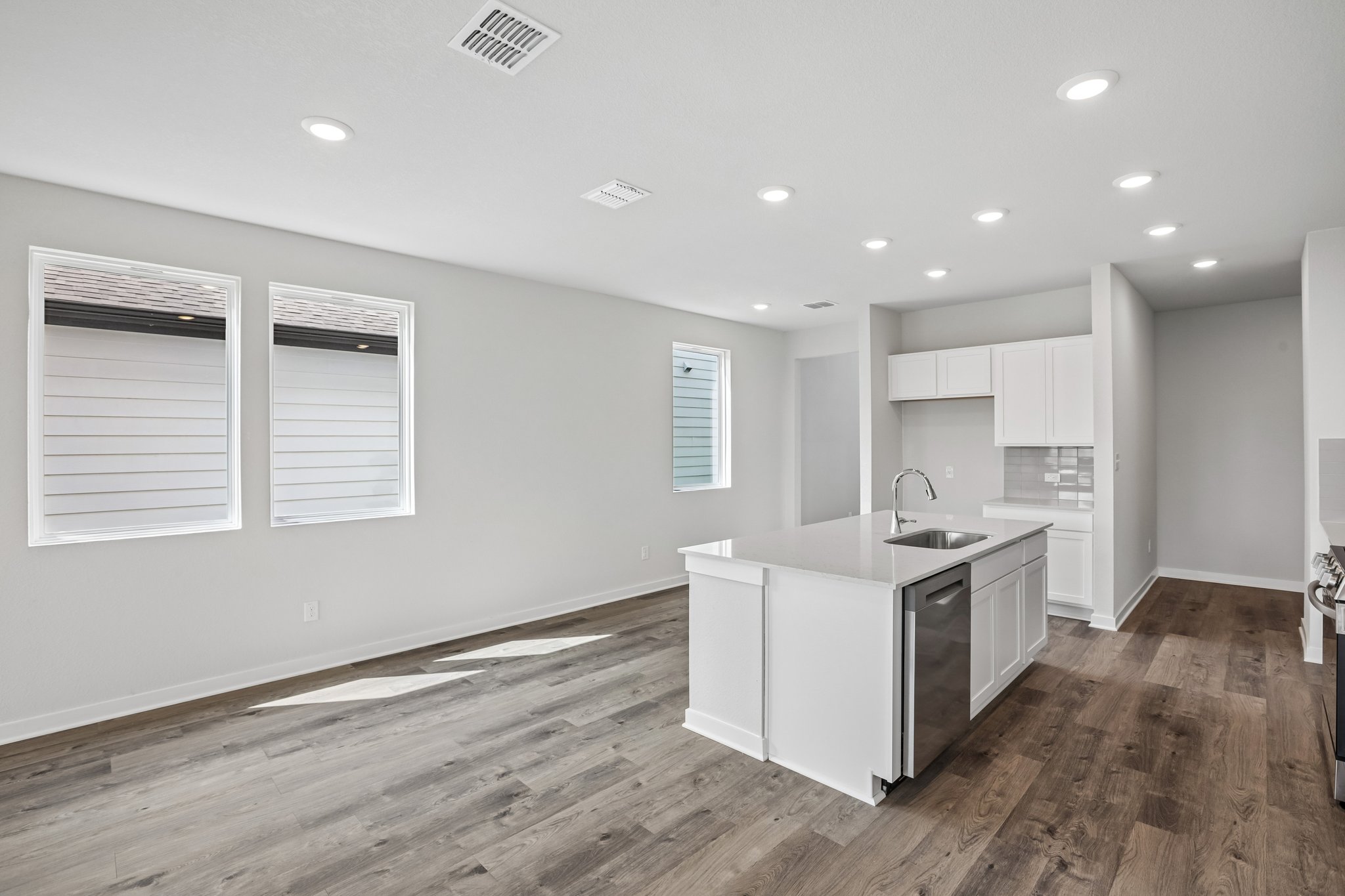 A kitchen with white cabinets.