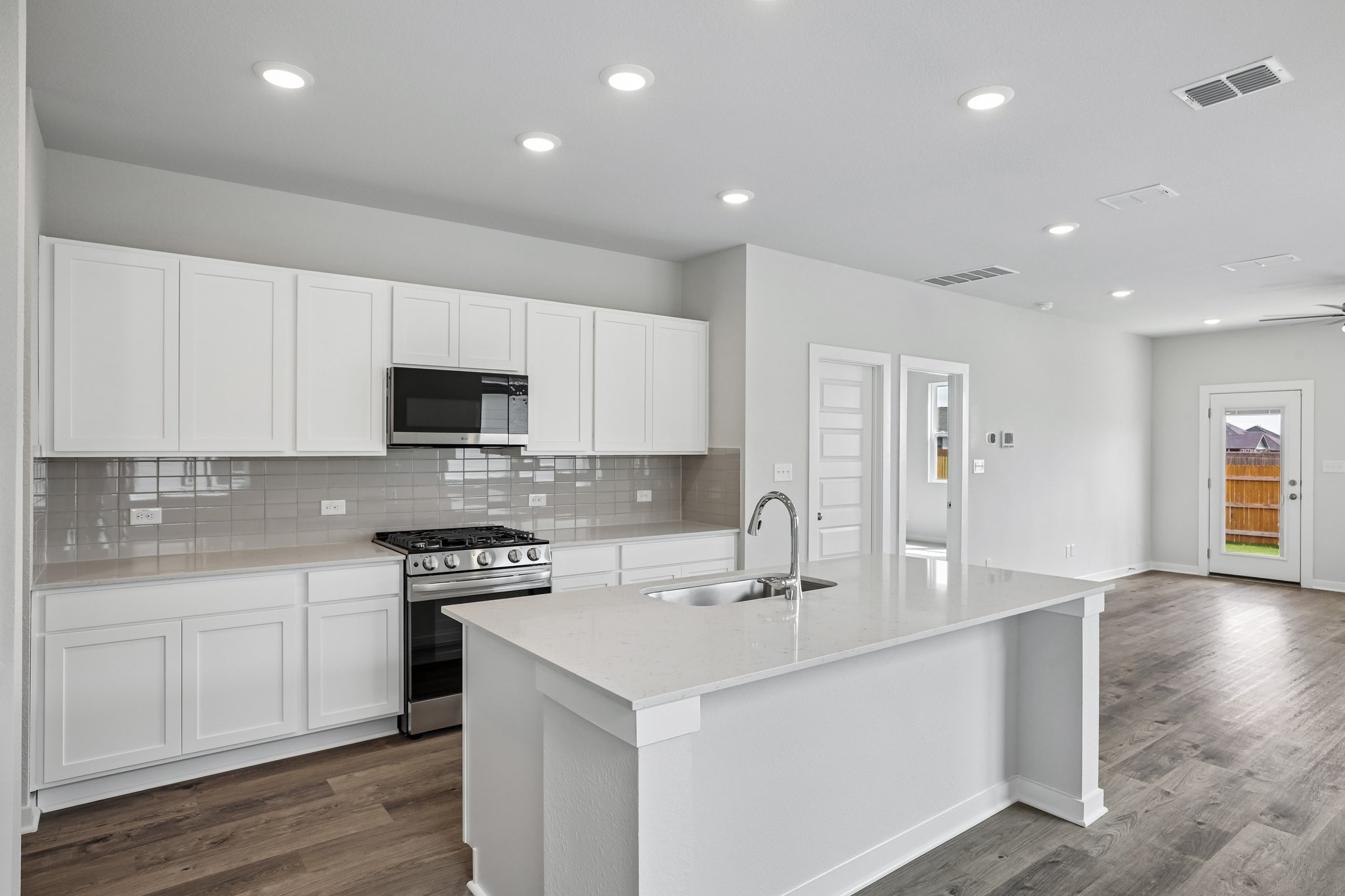 A kitchen with white cabinets.