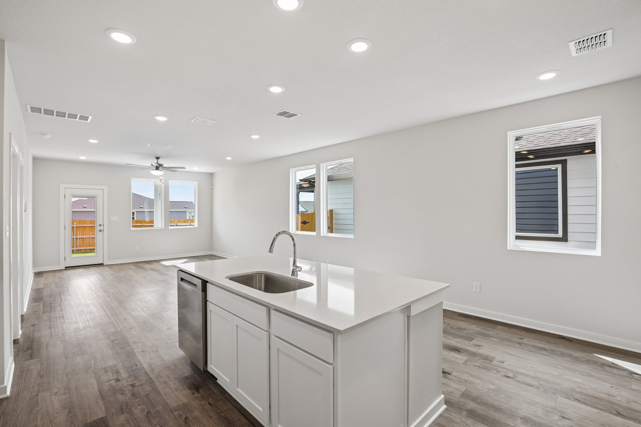 A kitchen with white cabinets.