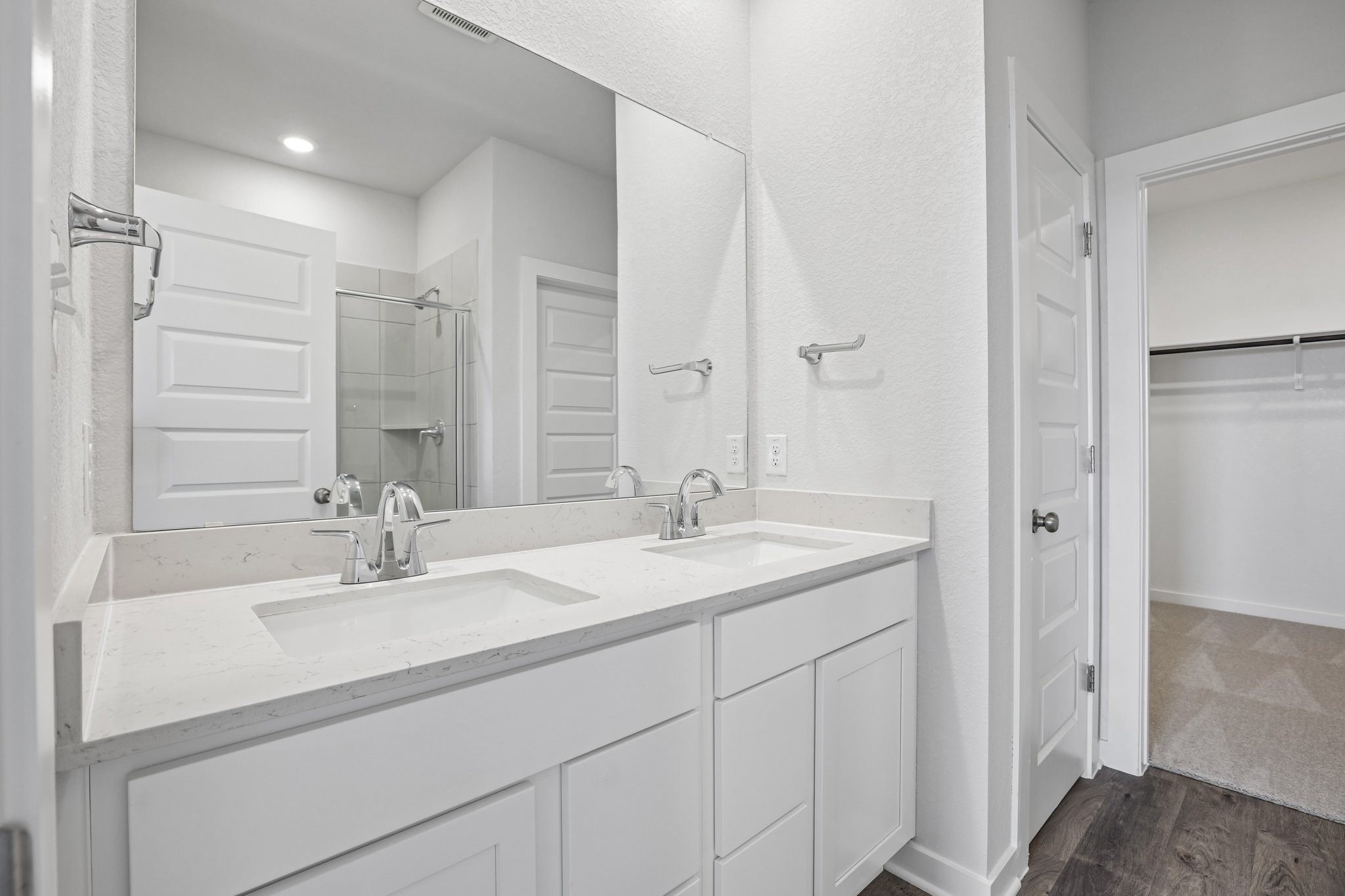 A bathroom with a large mirror.