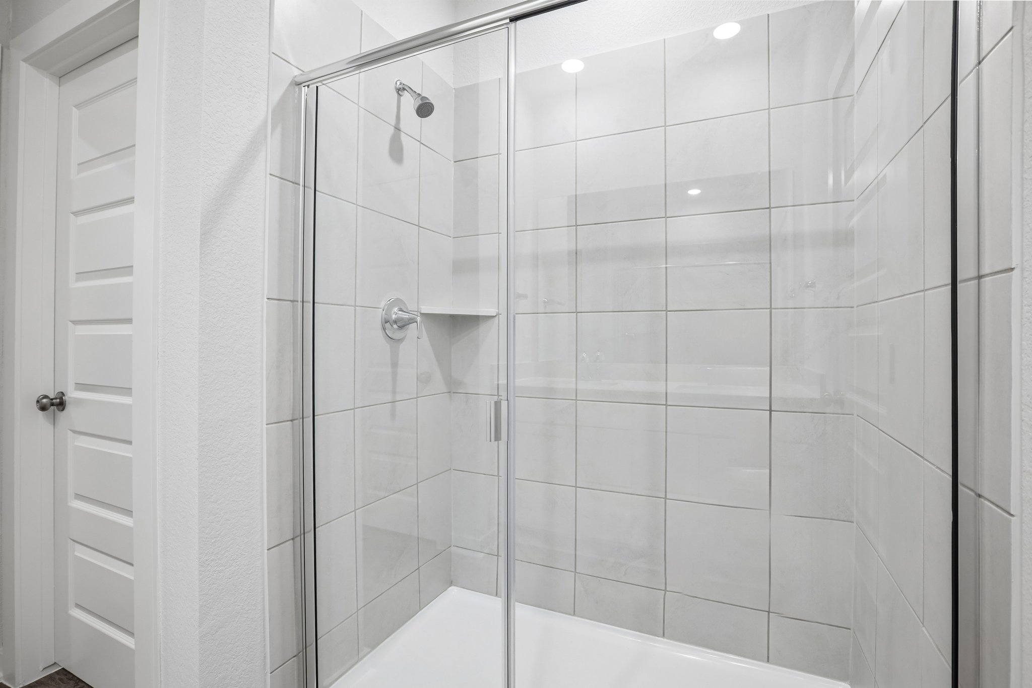 A shower with a glass door.