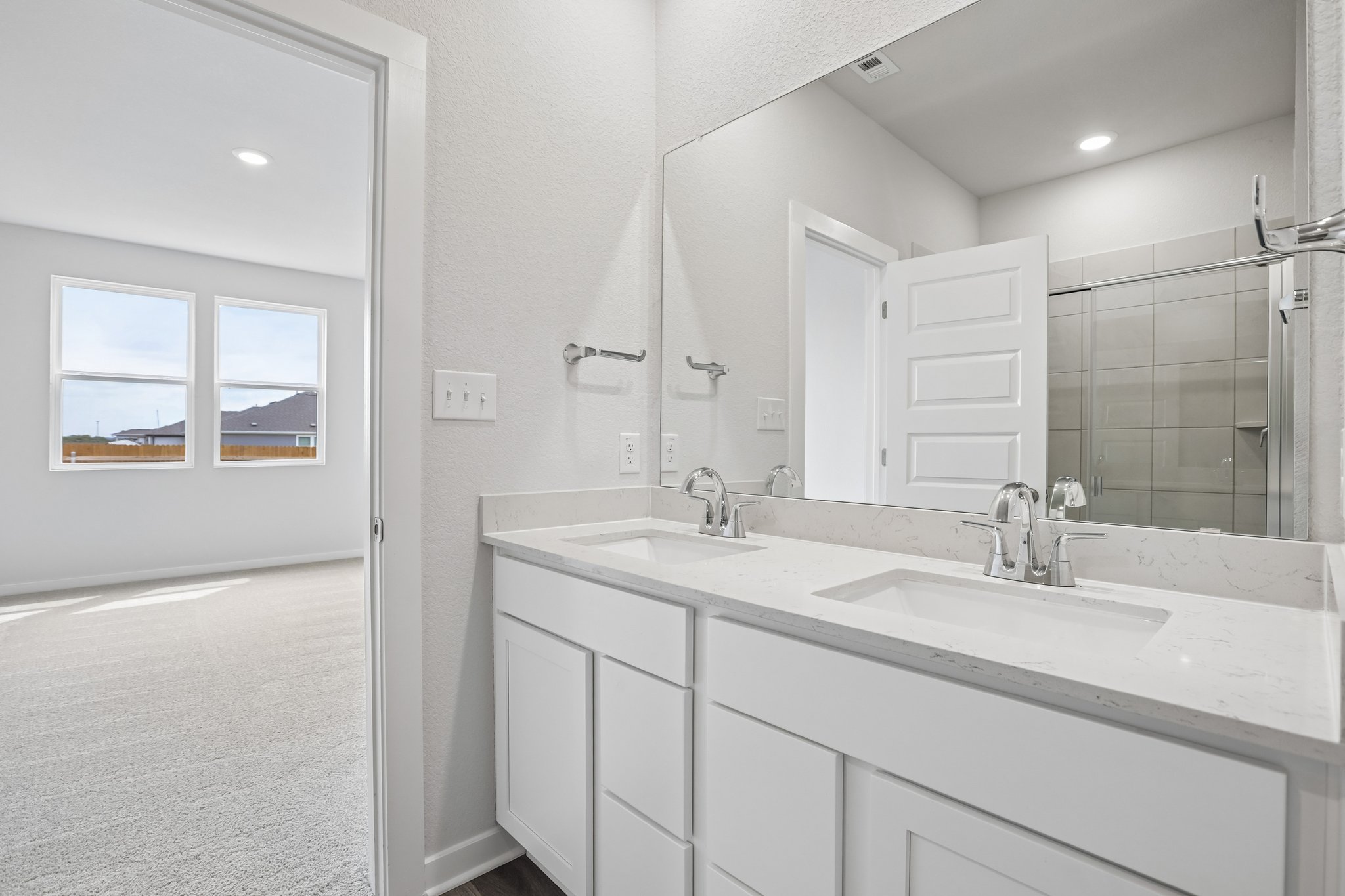 A bathroom with a large mirror.