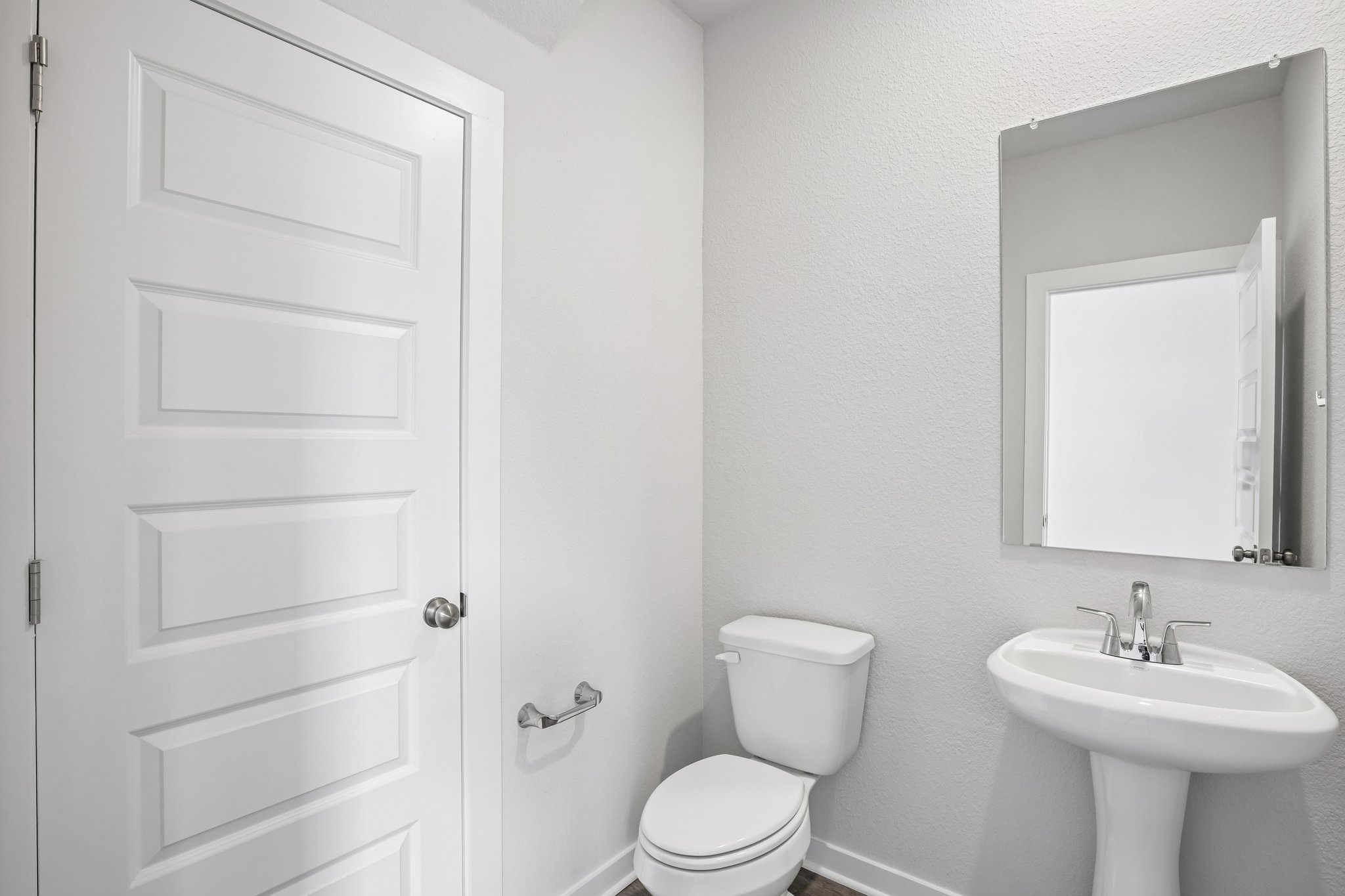 A bathroom with a toilet and sink.