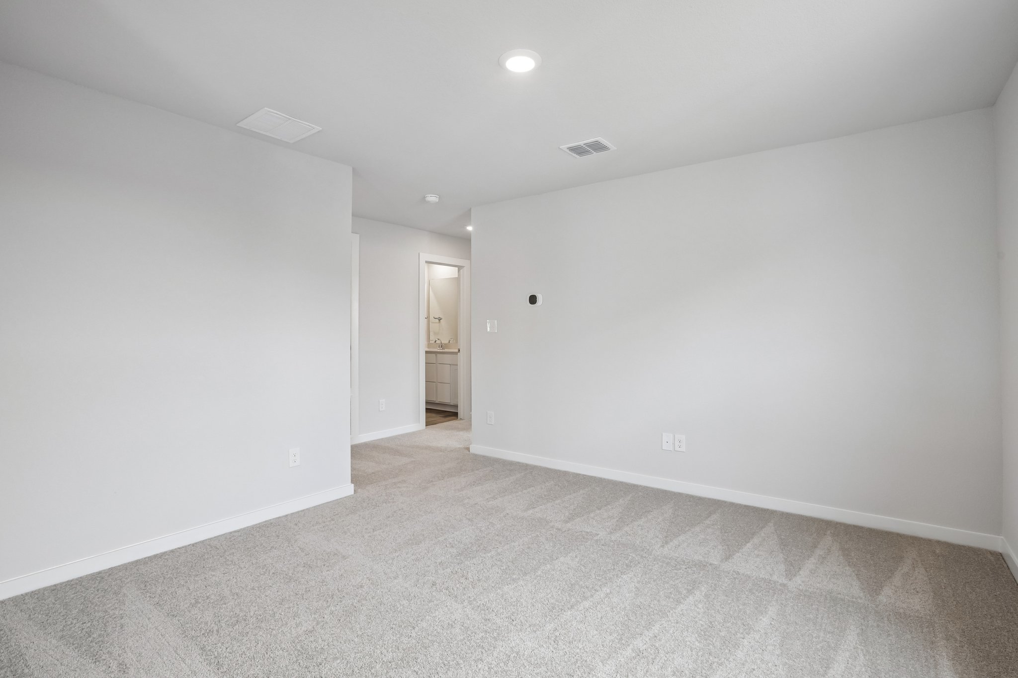 A hallway with white walls.