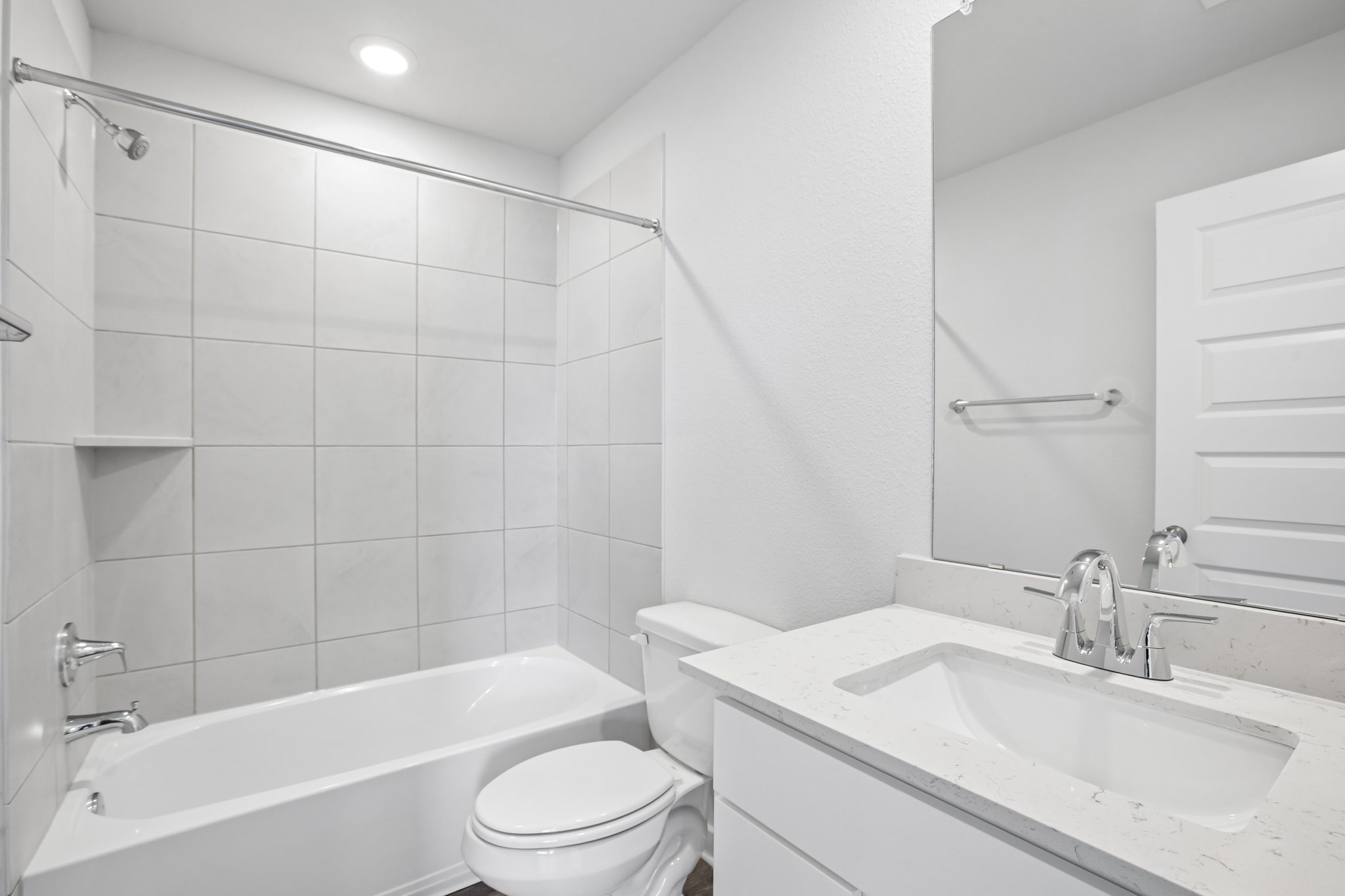 A bathroom with a tub sink and toilet.