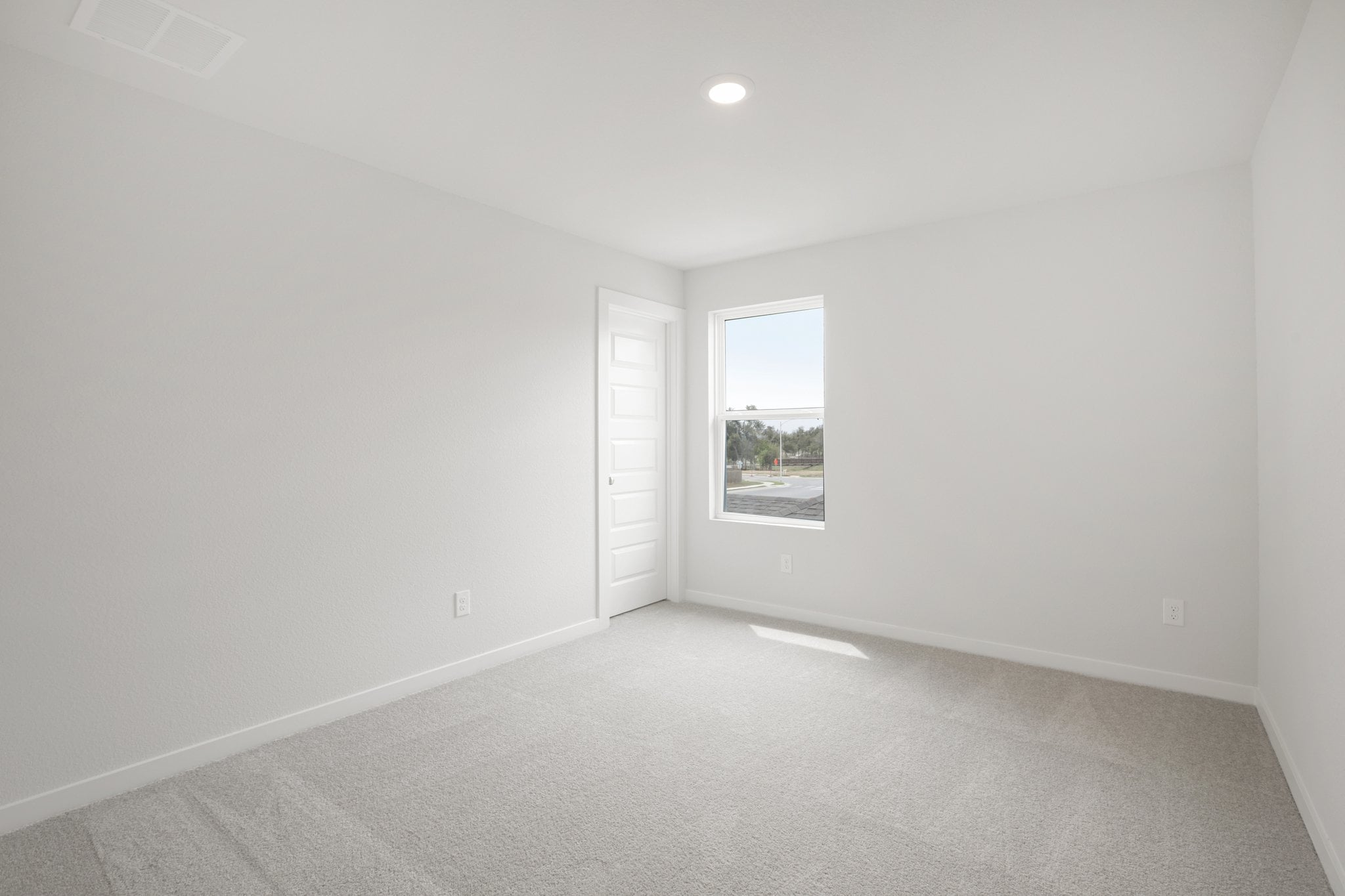 A room with a window and a door.