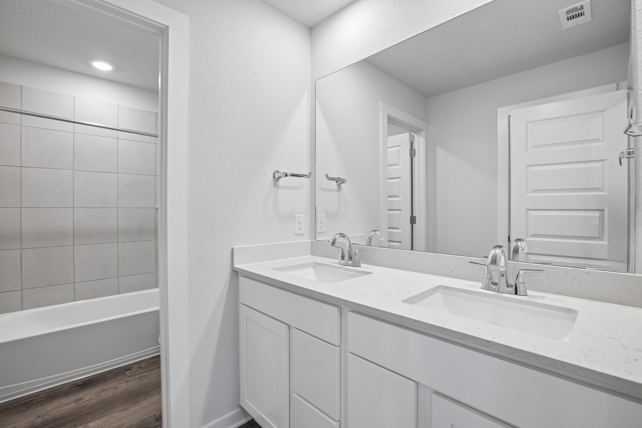 A bathroom with a large mirror.