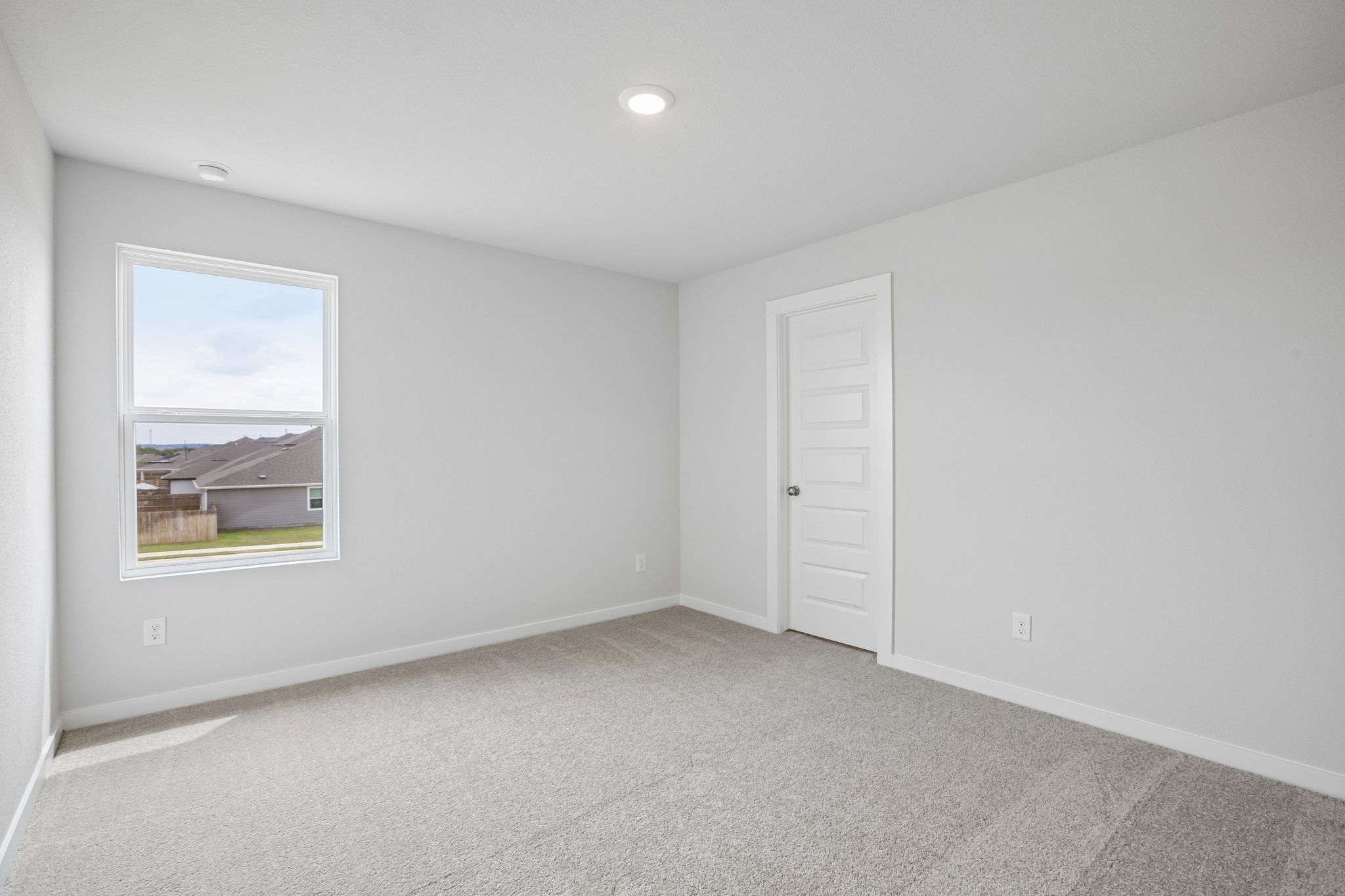 A room with a window and a door.