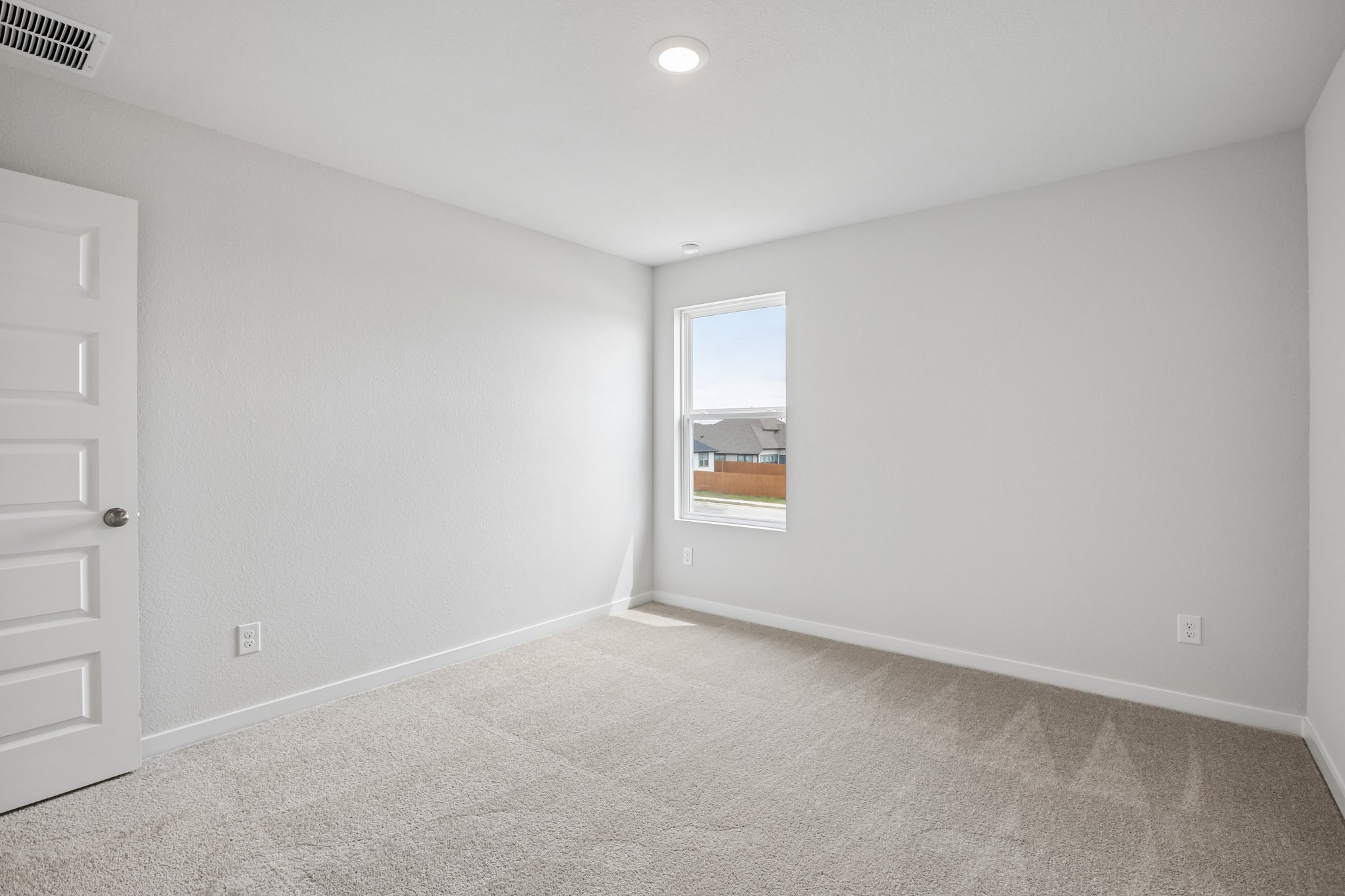 A room with a window and a door.