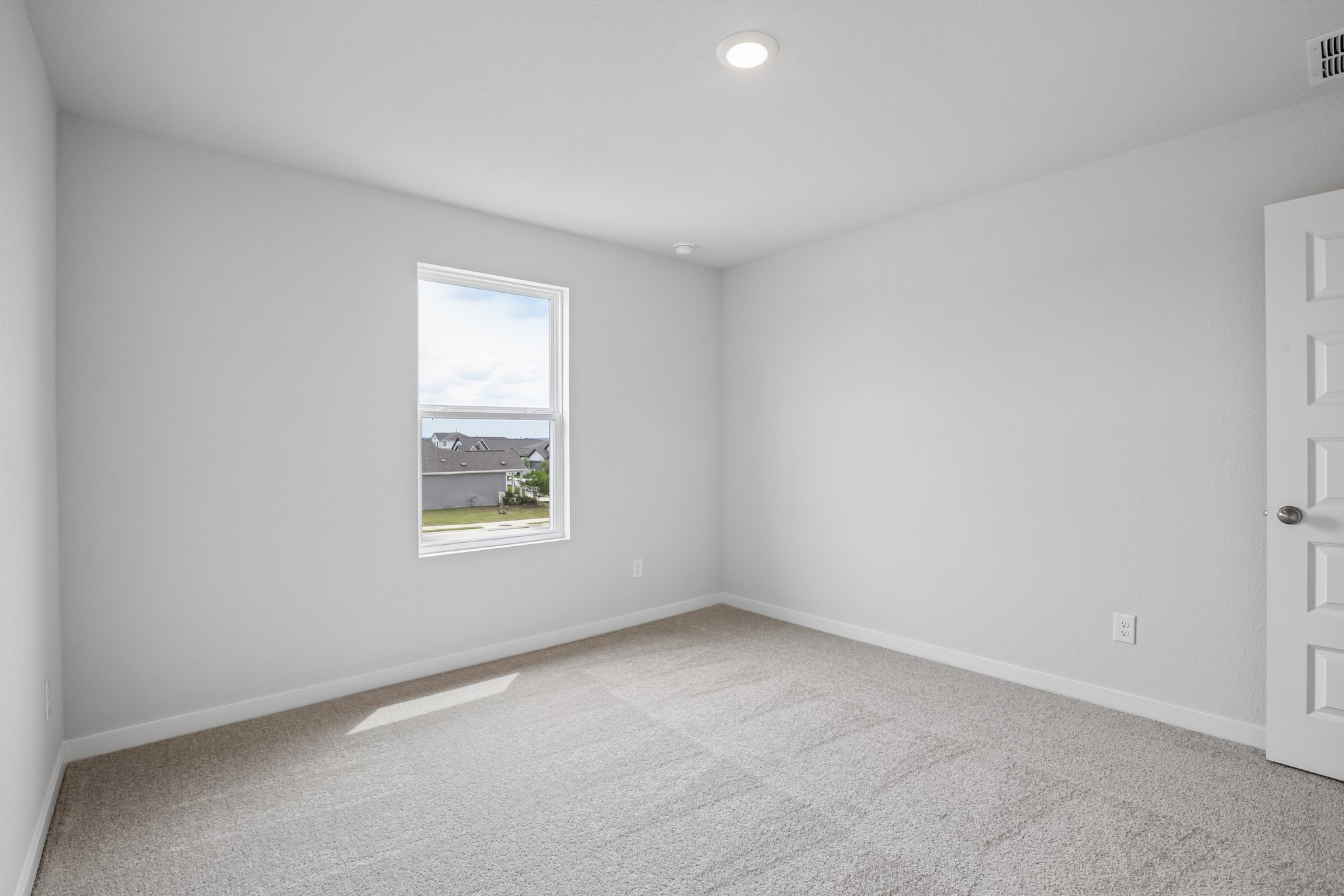 A room with a window and a door.