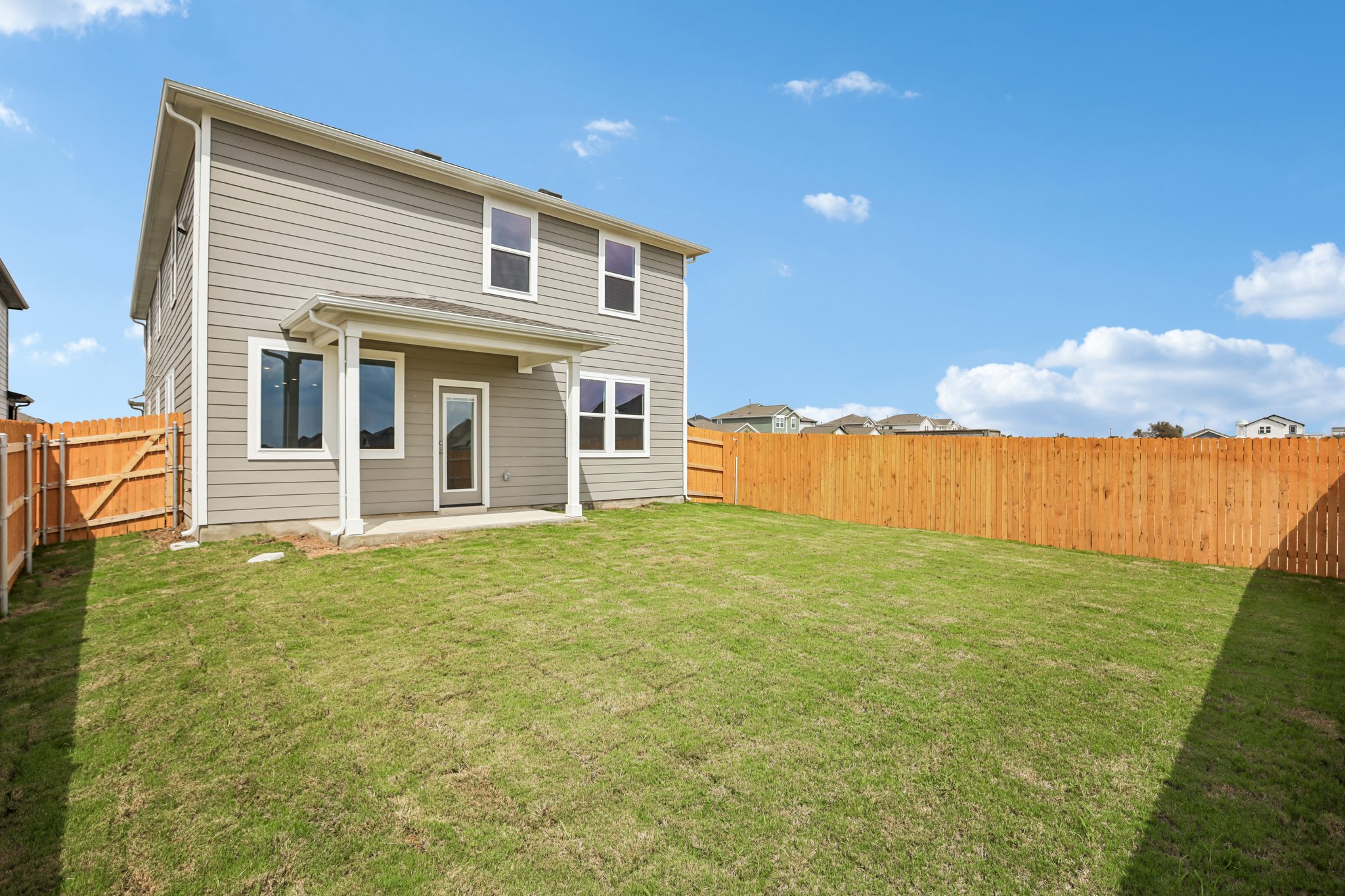 A house with a fence and grass.