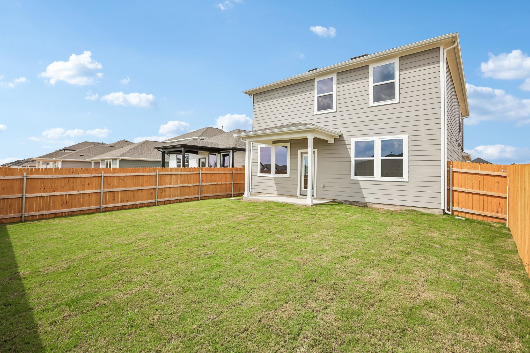 A house with a fence and grass.