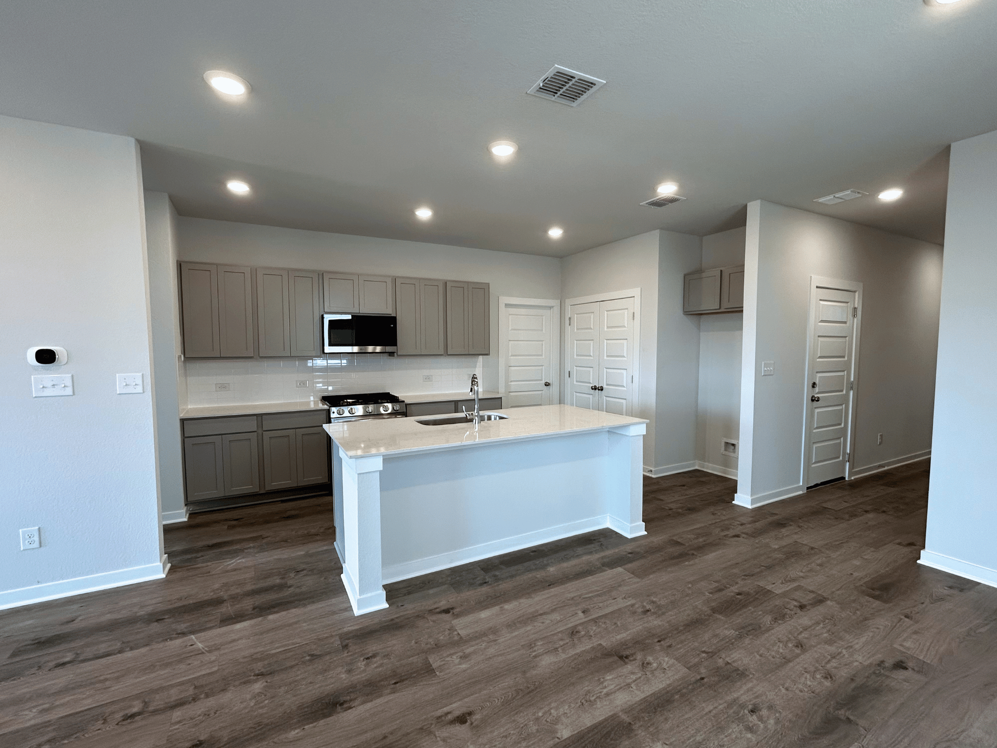 A kitchen with white cabinets.