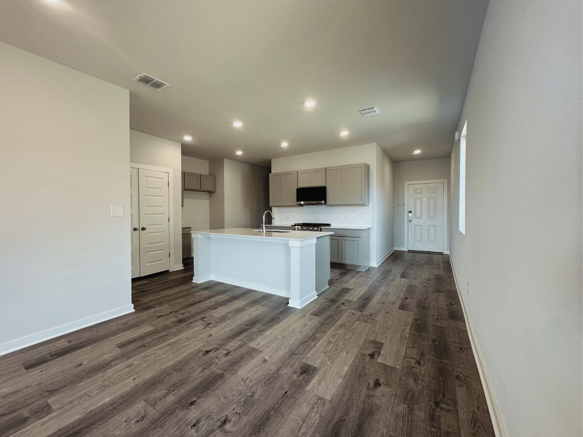 A kitchen with white cabinets.
