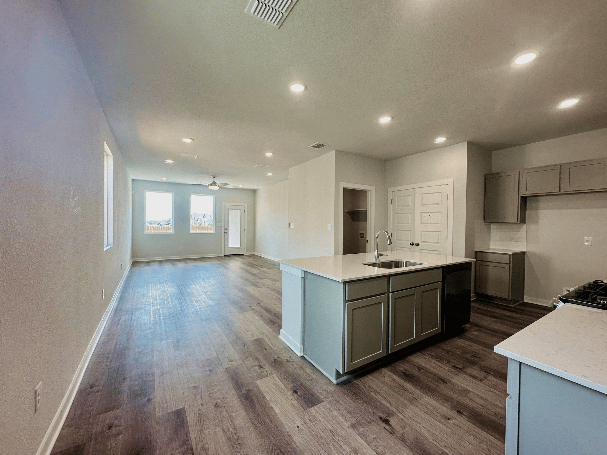A kitchen with a wood floor.