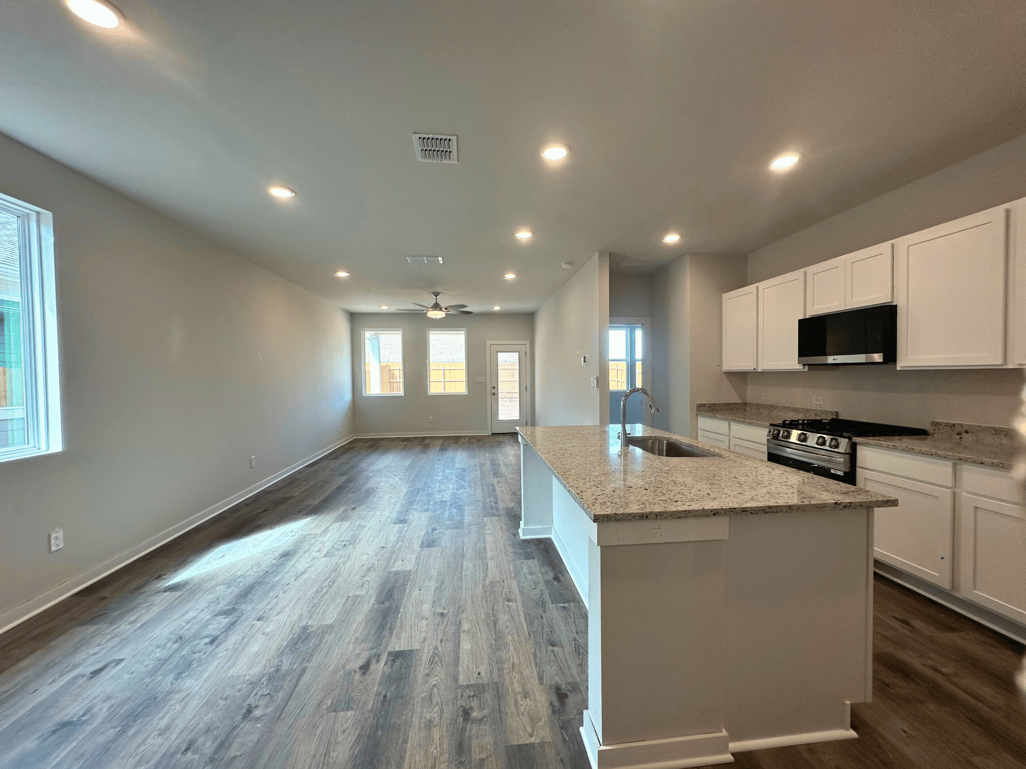 A kitchen with white cabinets.