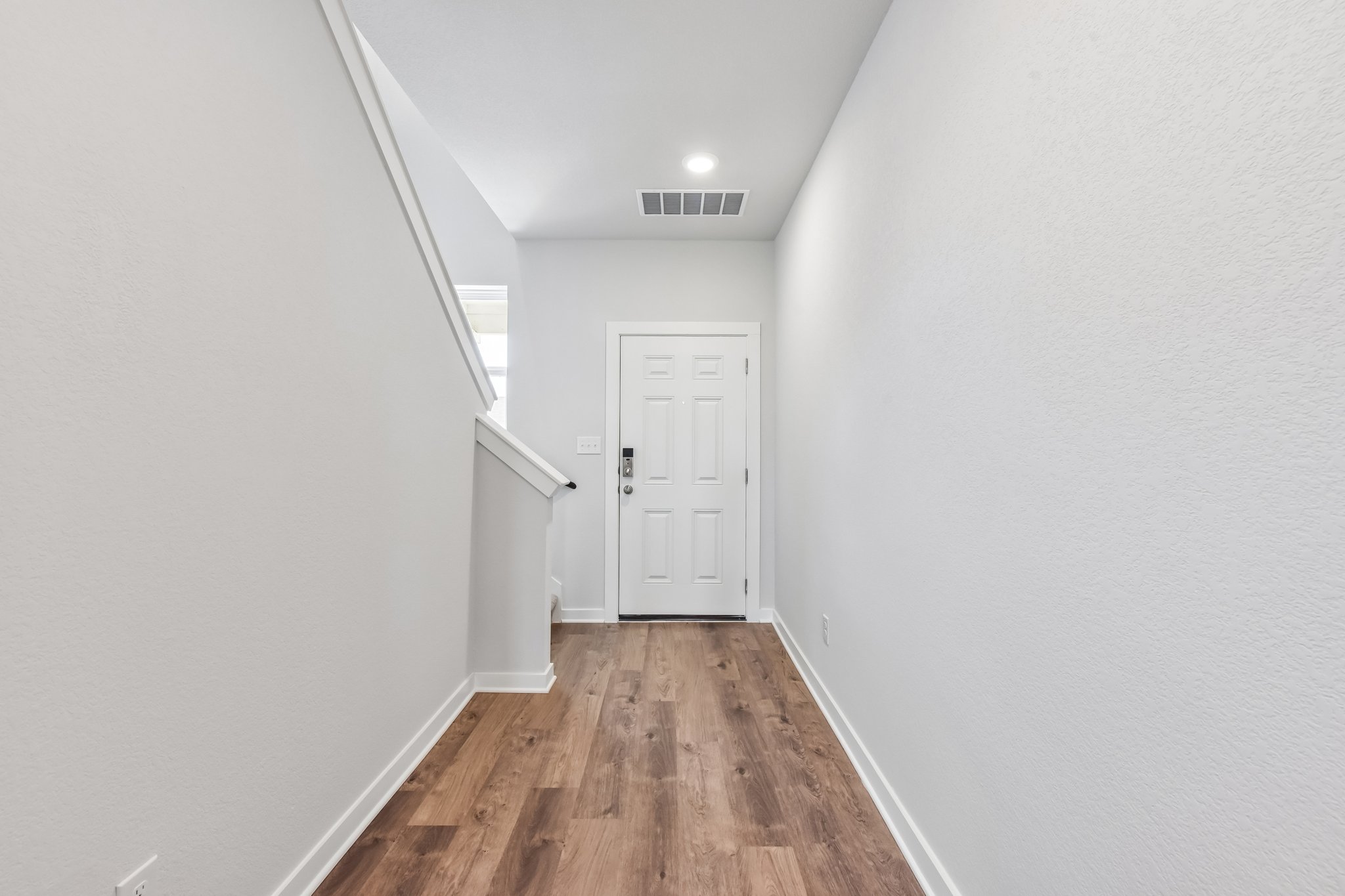 A hallway with white doors.