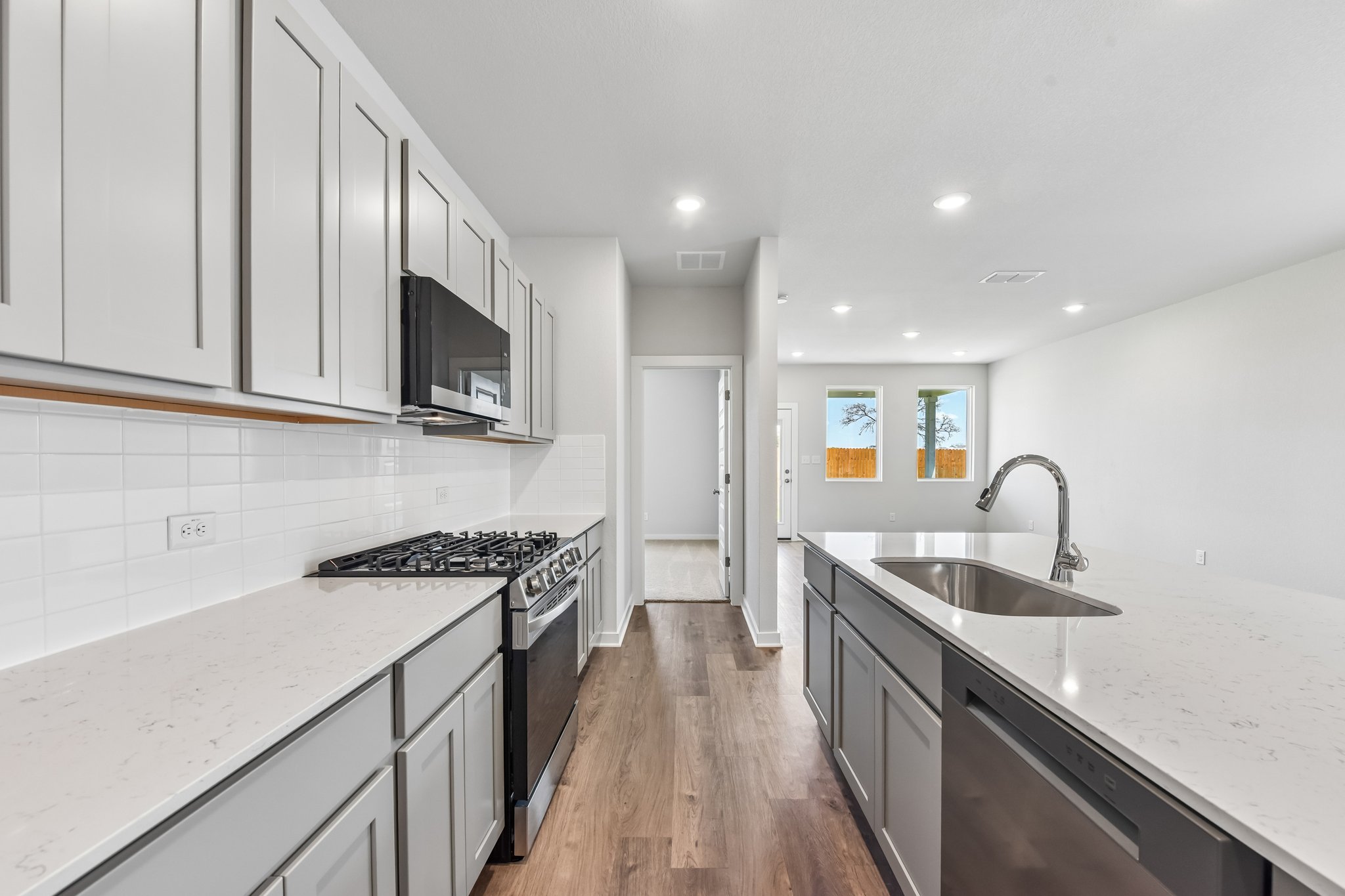 A kitchen with white cabinets.