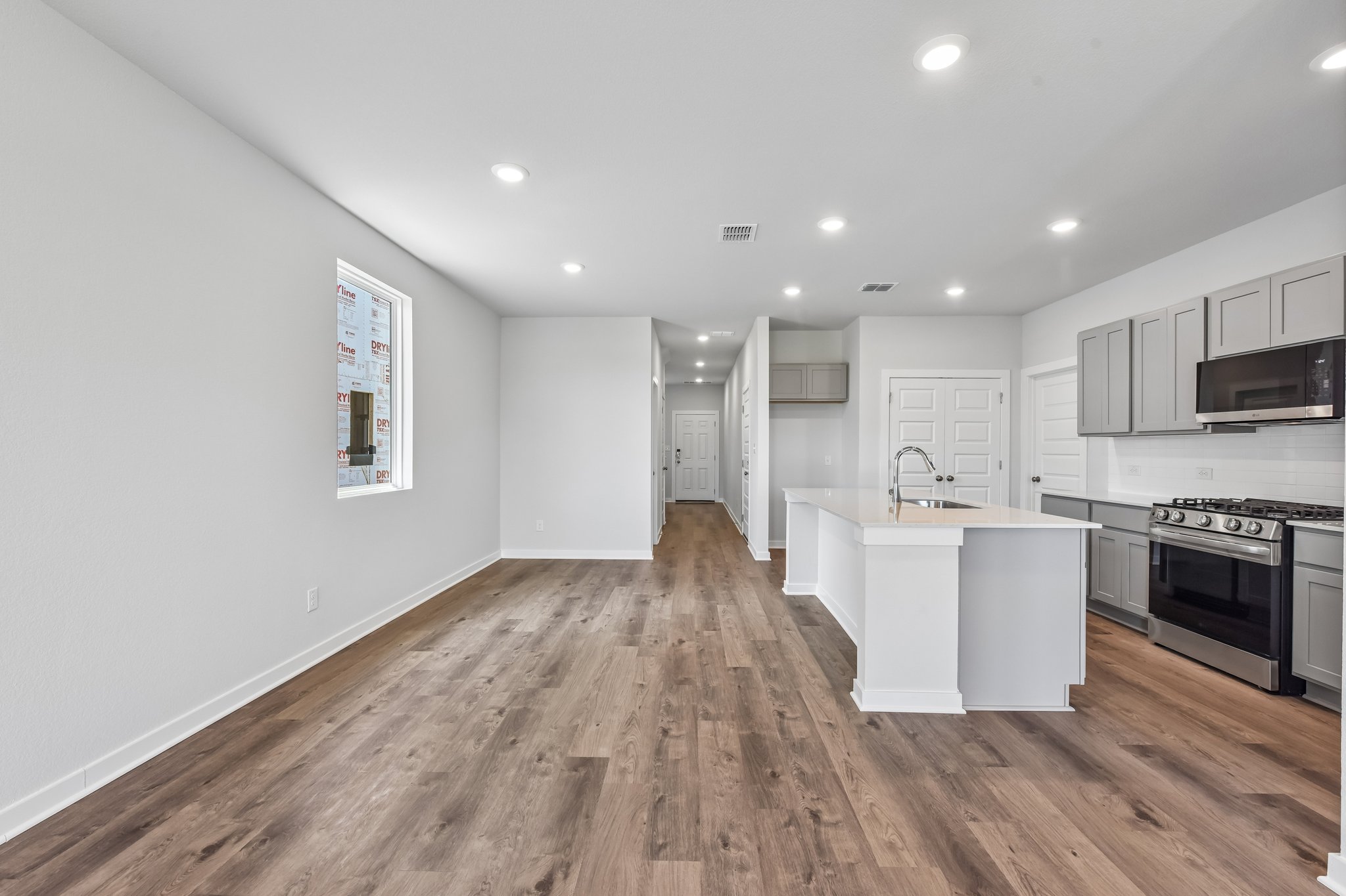 A kitchen with white cabinets.