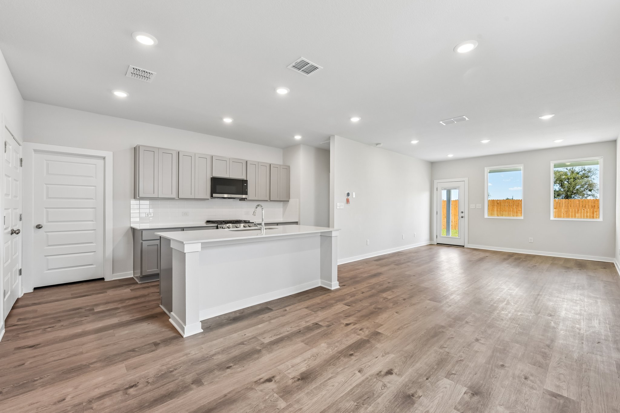 A large kitchen with white cabinets.