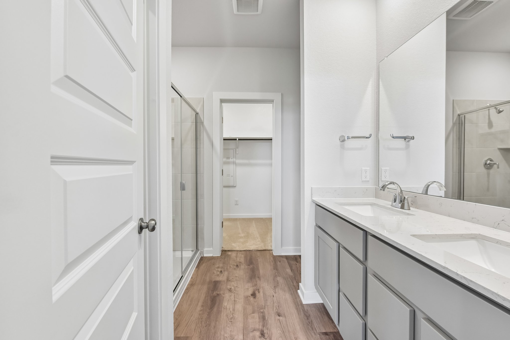 A bathroom with white cabinets.