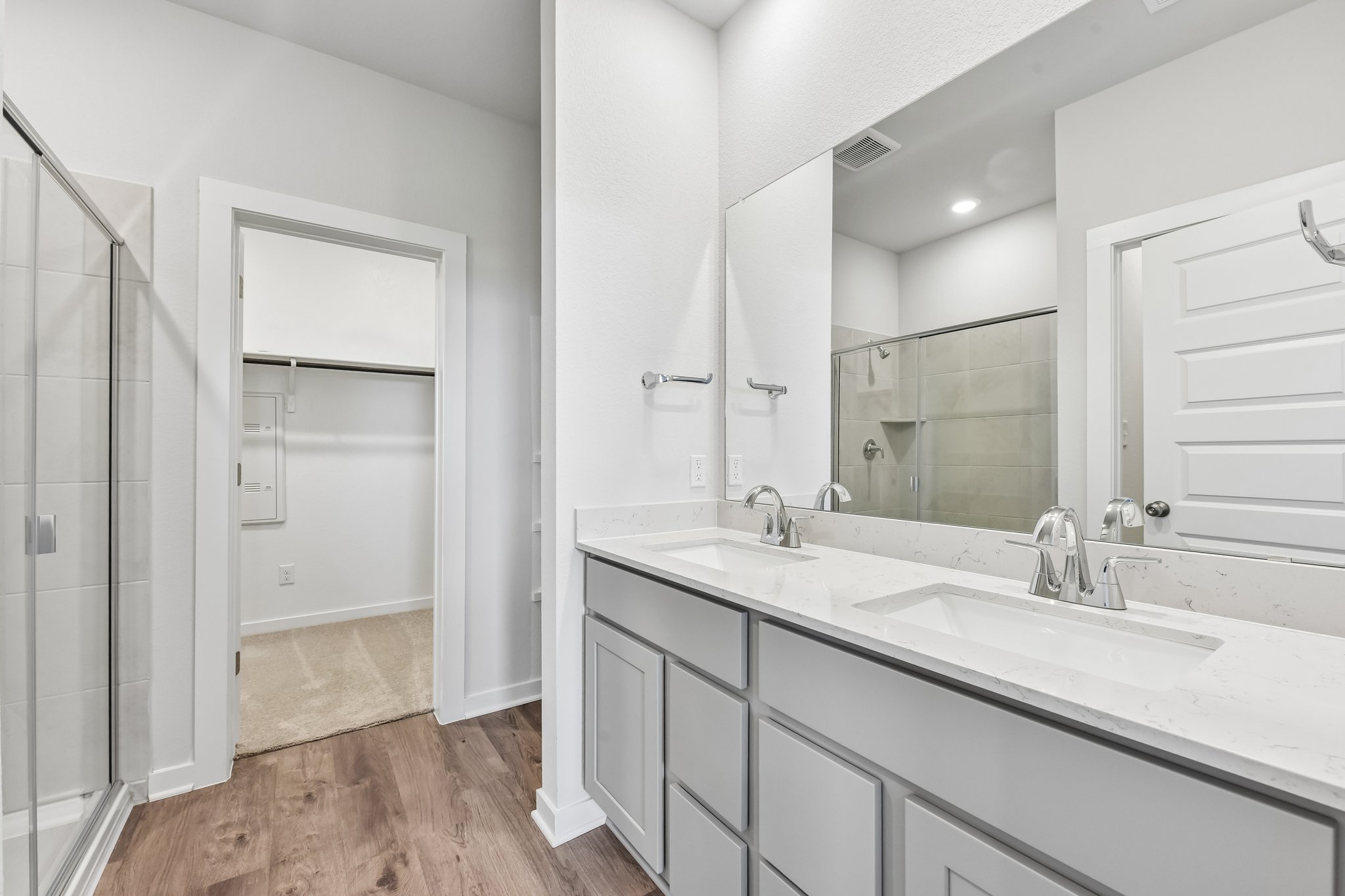 A bathroom with a large mirror.