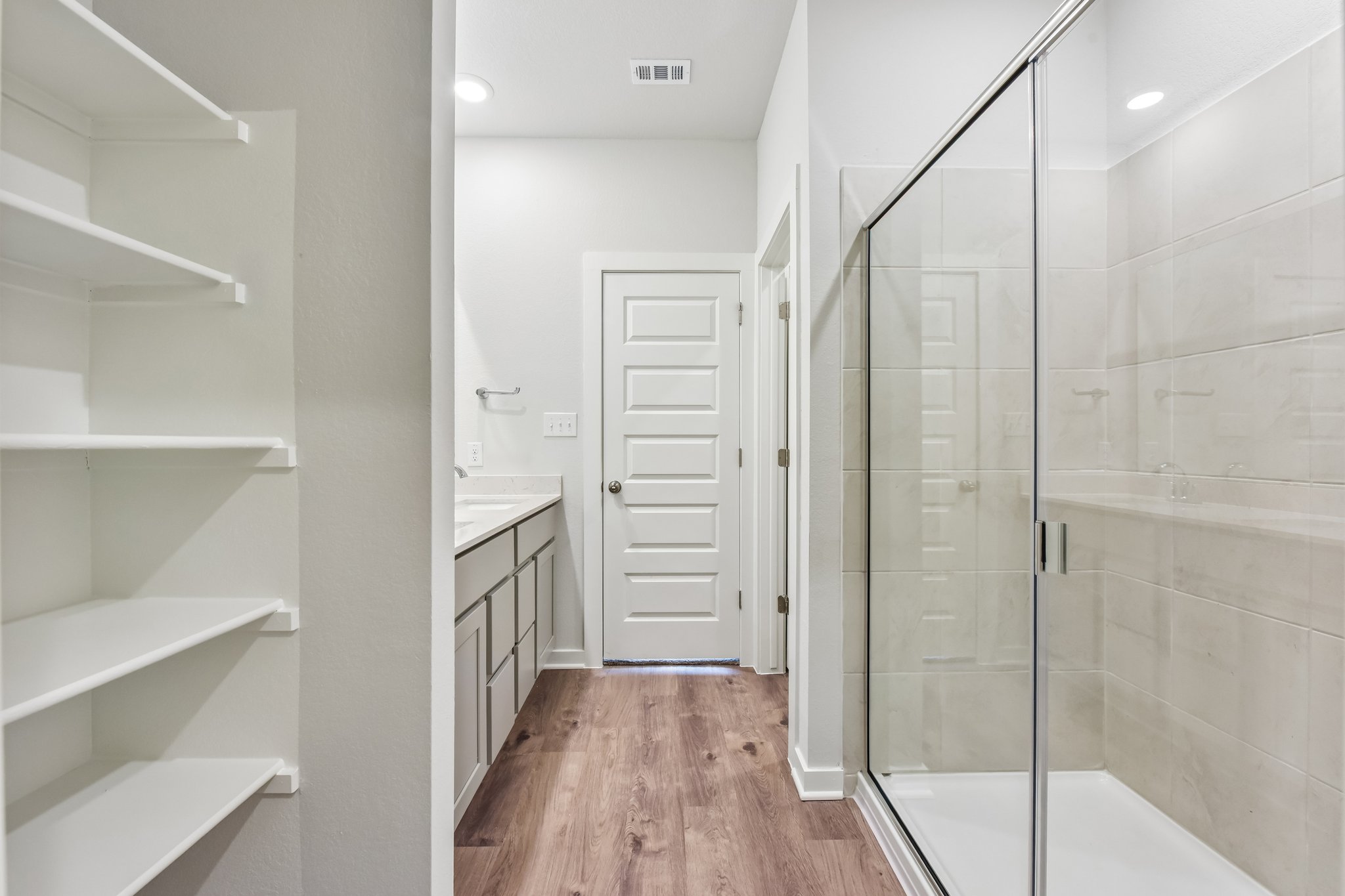 A white bathroom with a glass shower.