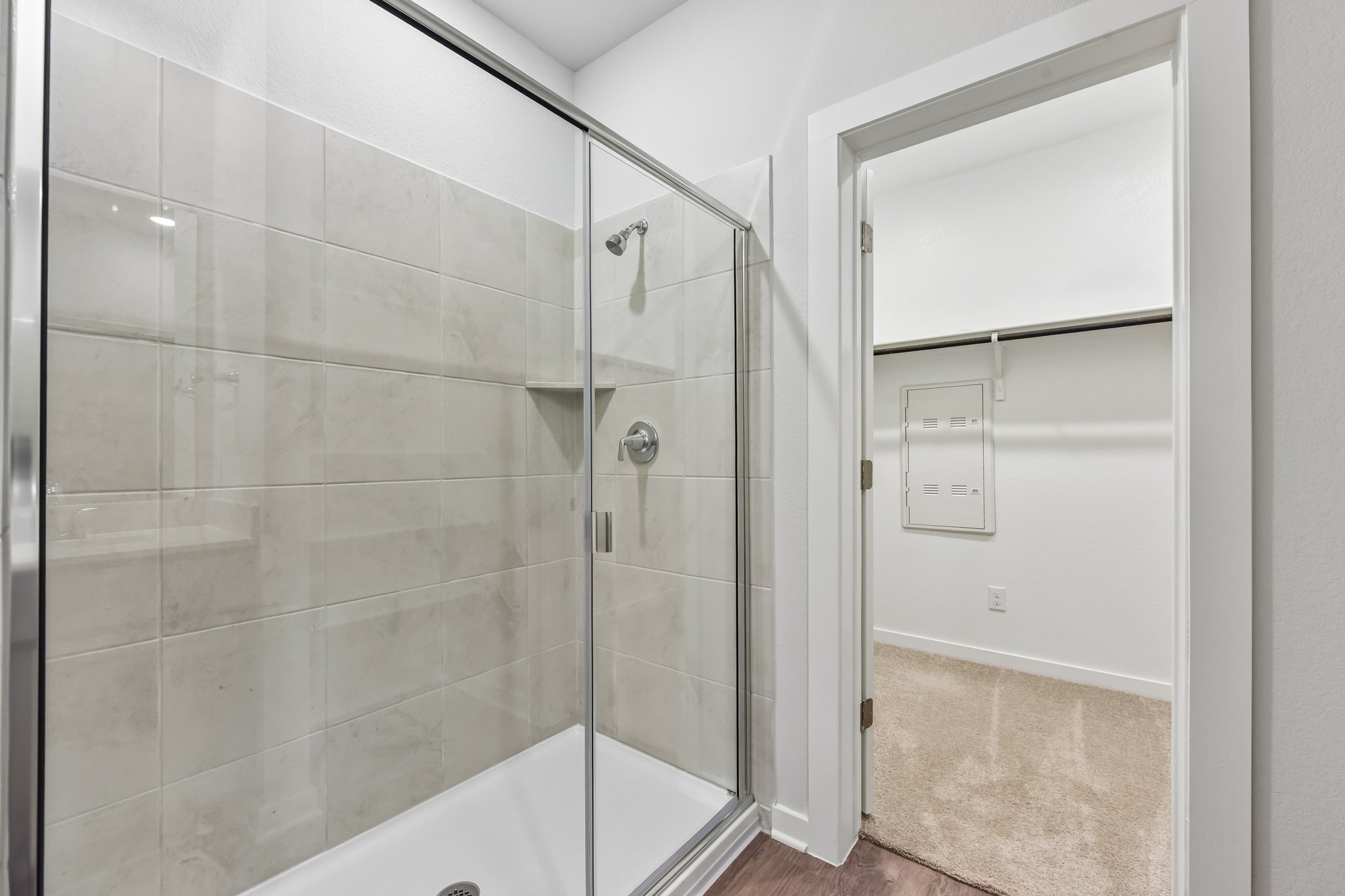 A shower with a glass door.