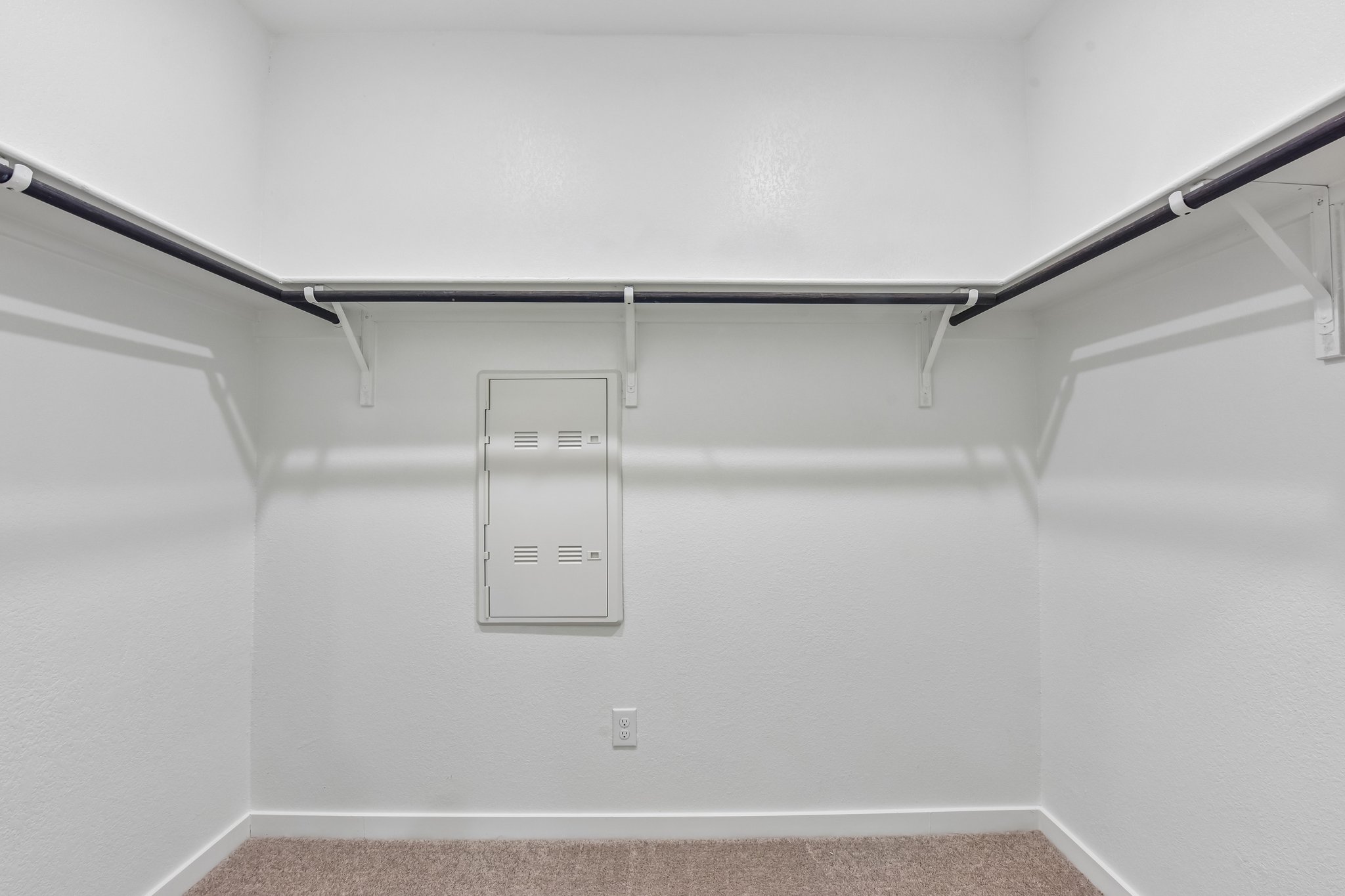 A white wall with a light fixture.