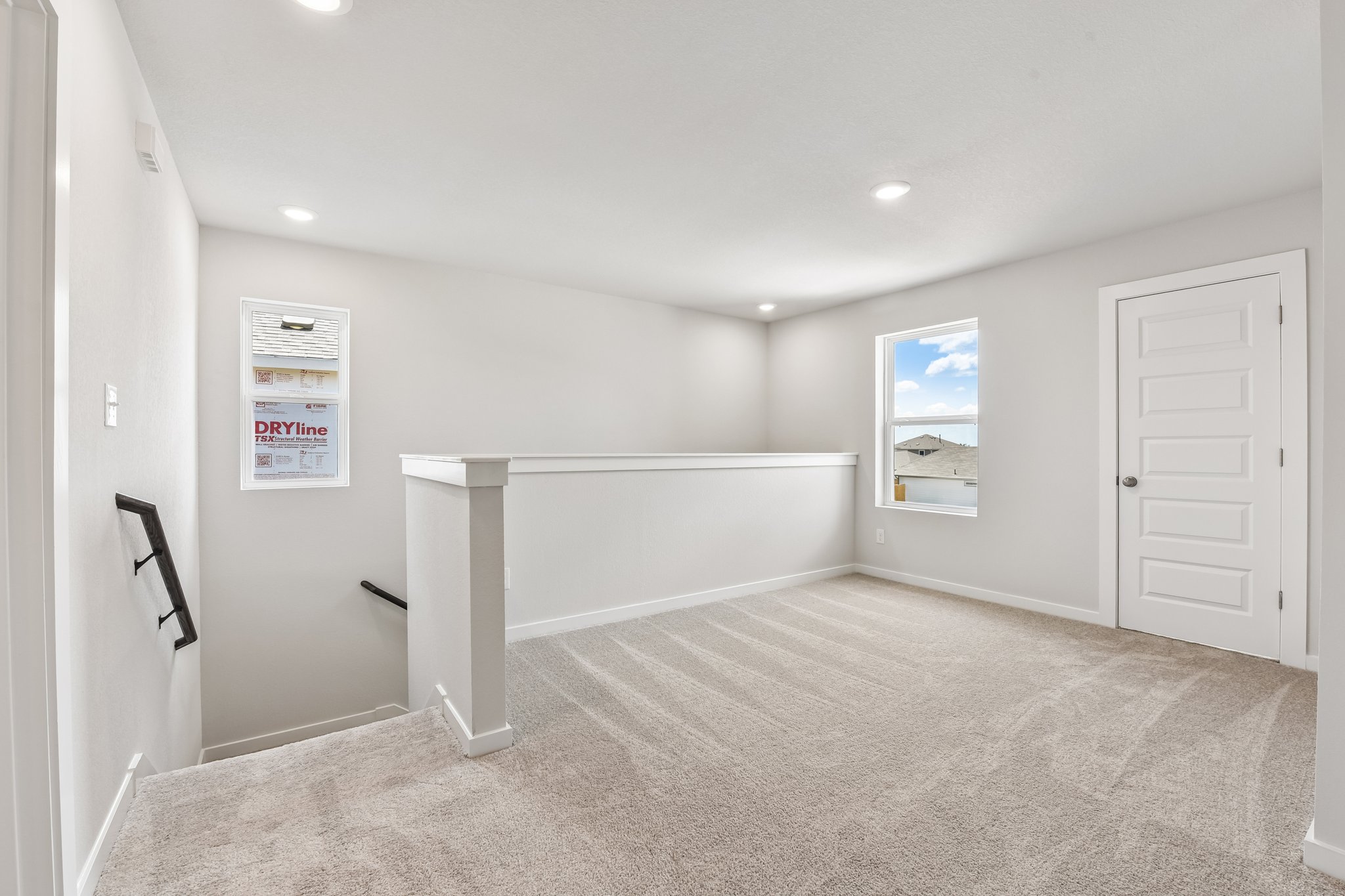 A white room with a bench.