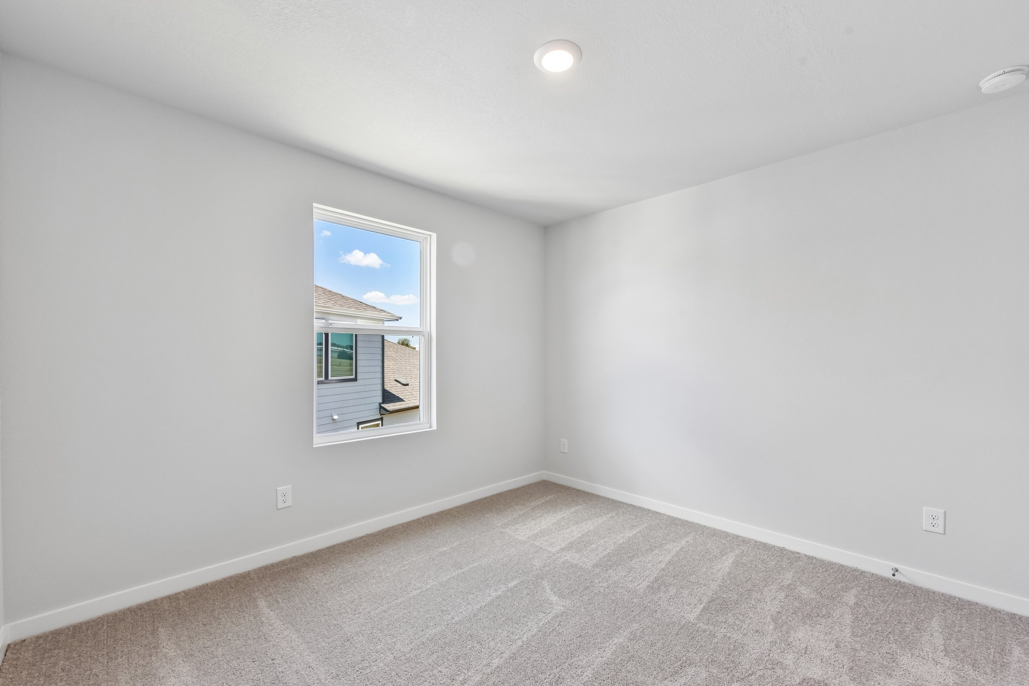 A white room with a painting on the wall.