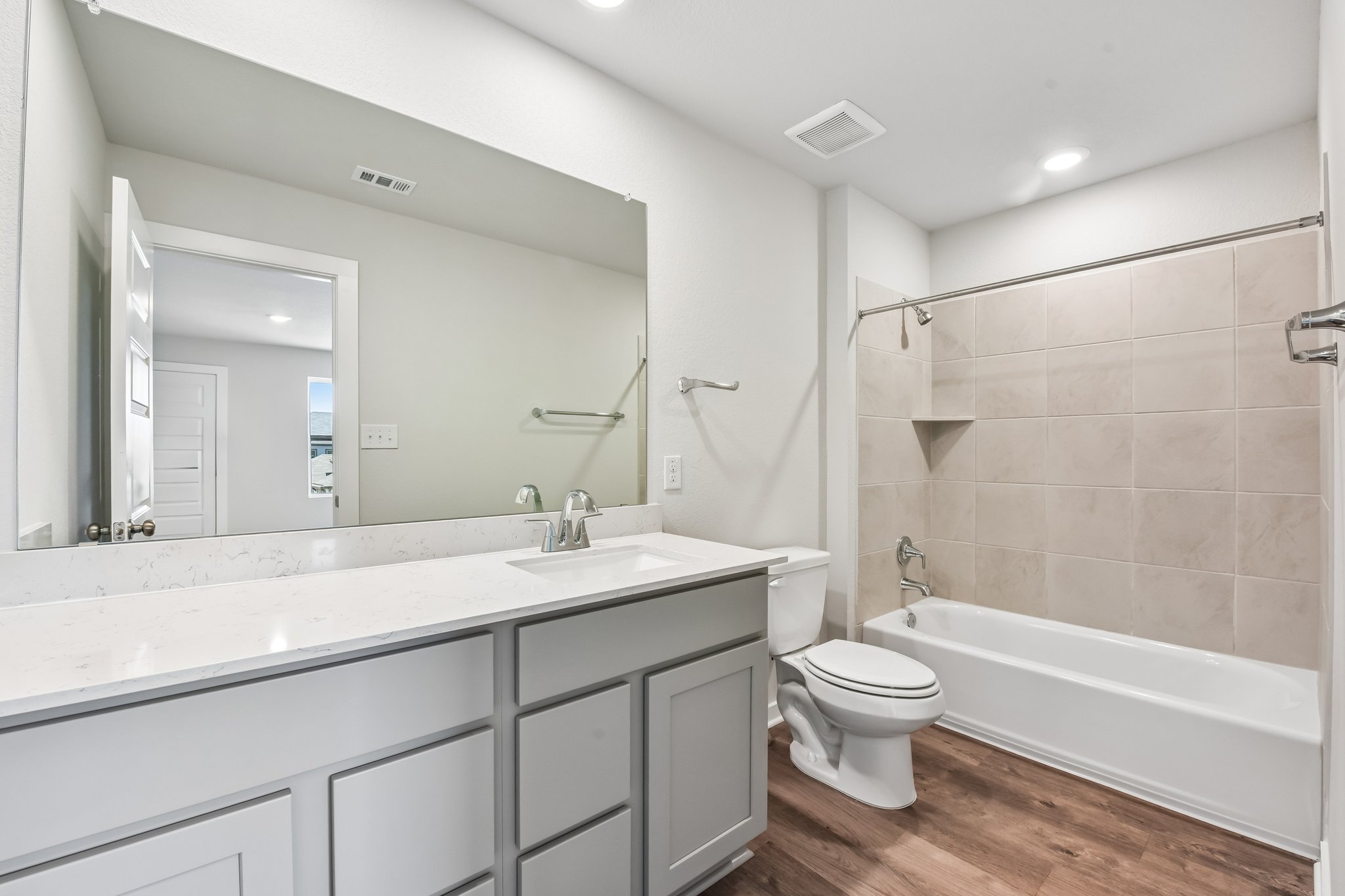 A bathroom with a tub sink and toilet.