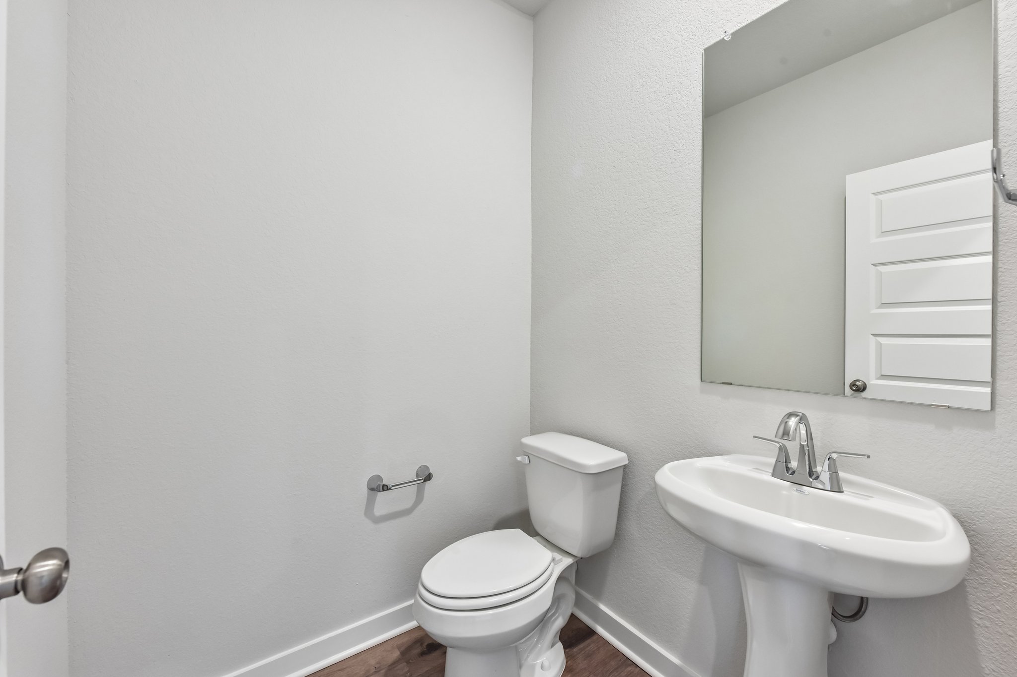 A bathroom with a toilet and sink.