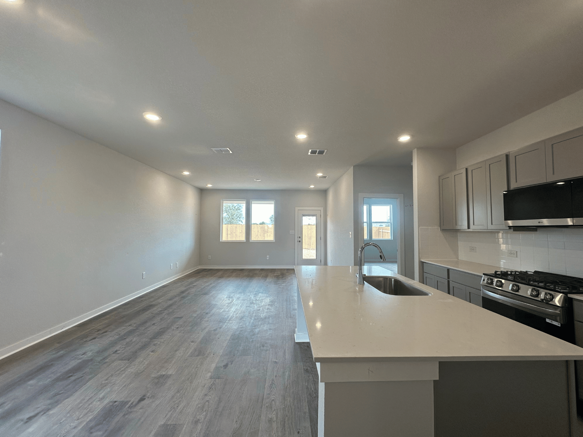A kitchen with a wood floor.