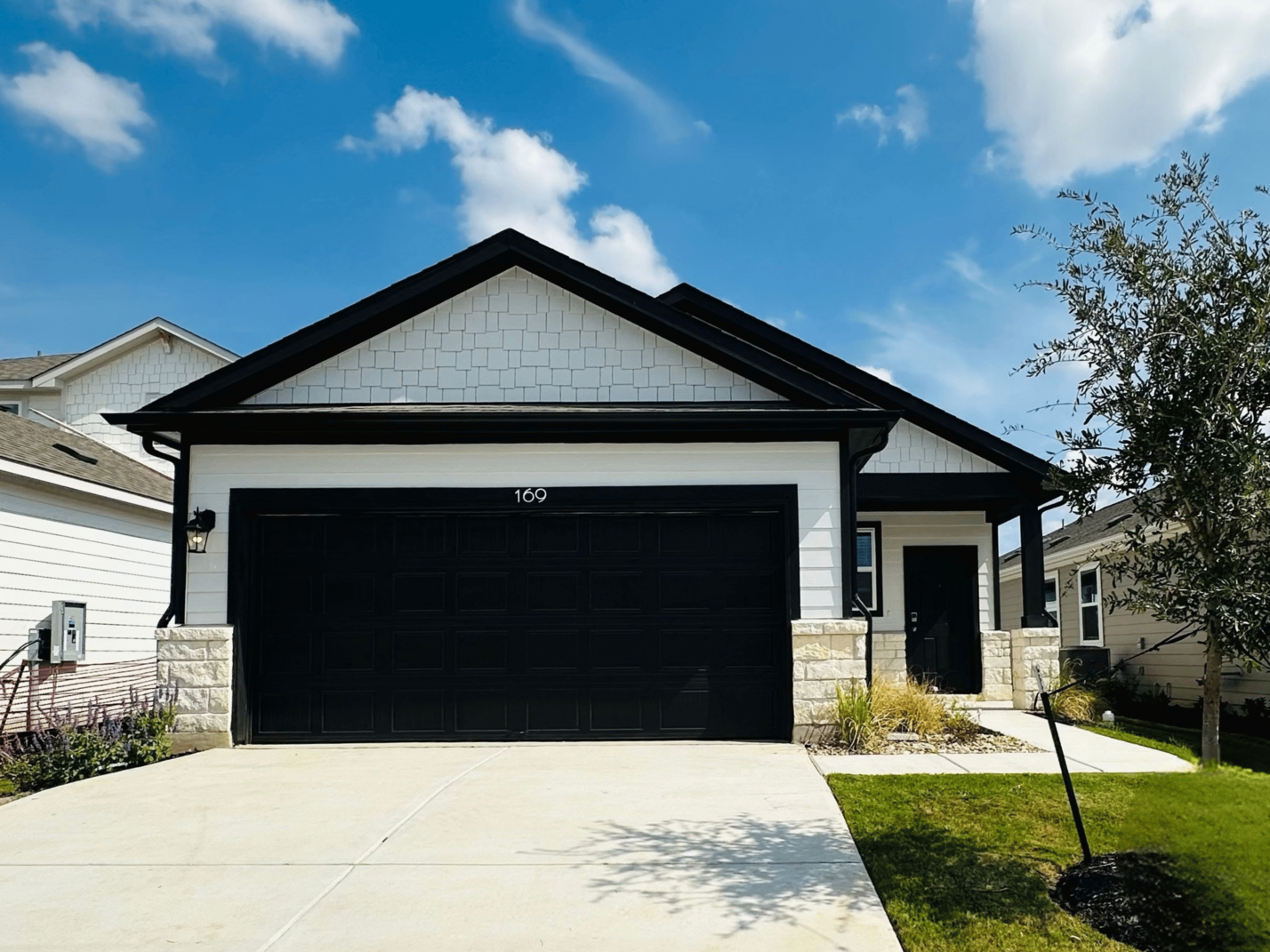 A garage with a garage with American Gothic House in the background.